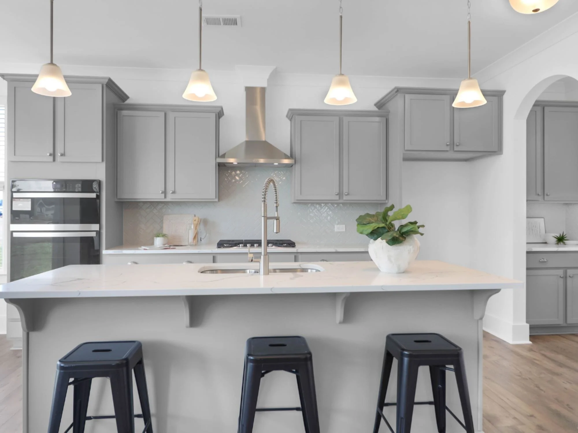 black bar stools and plant on kitchen island - staging a kitchen charleston, SC