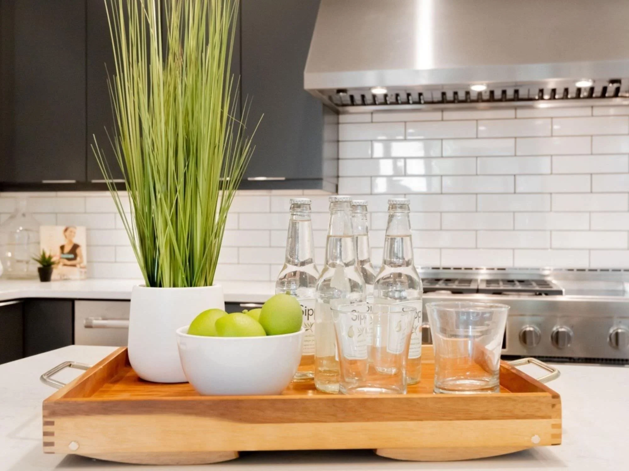 tray, greenery and water glasses and bottles in kitchen