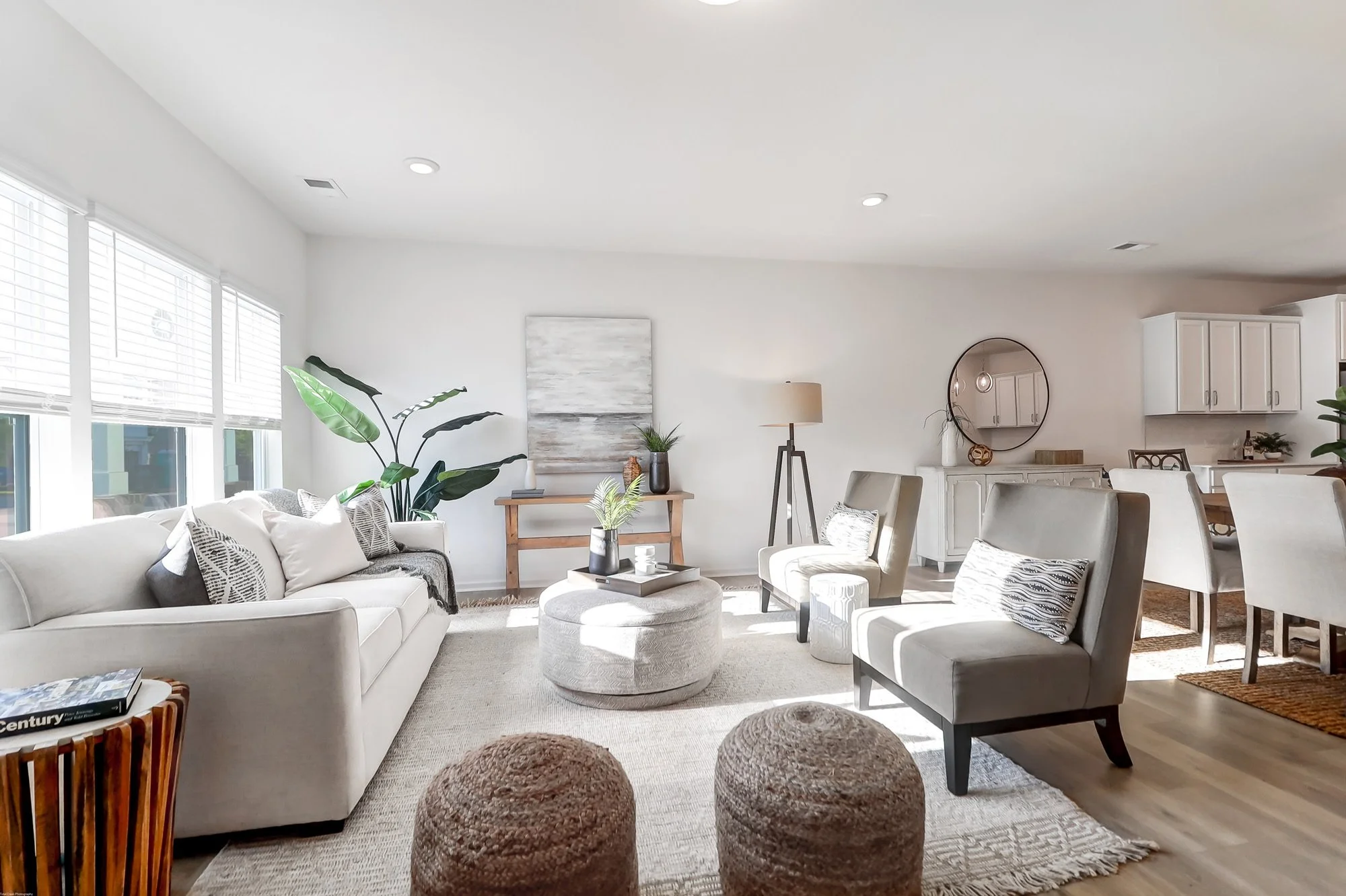 white couch, beige chairs, coffee table and lamp in home