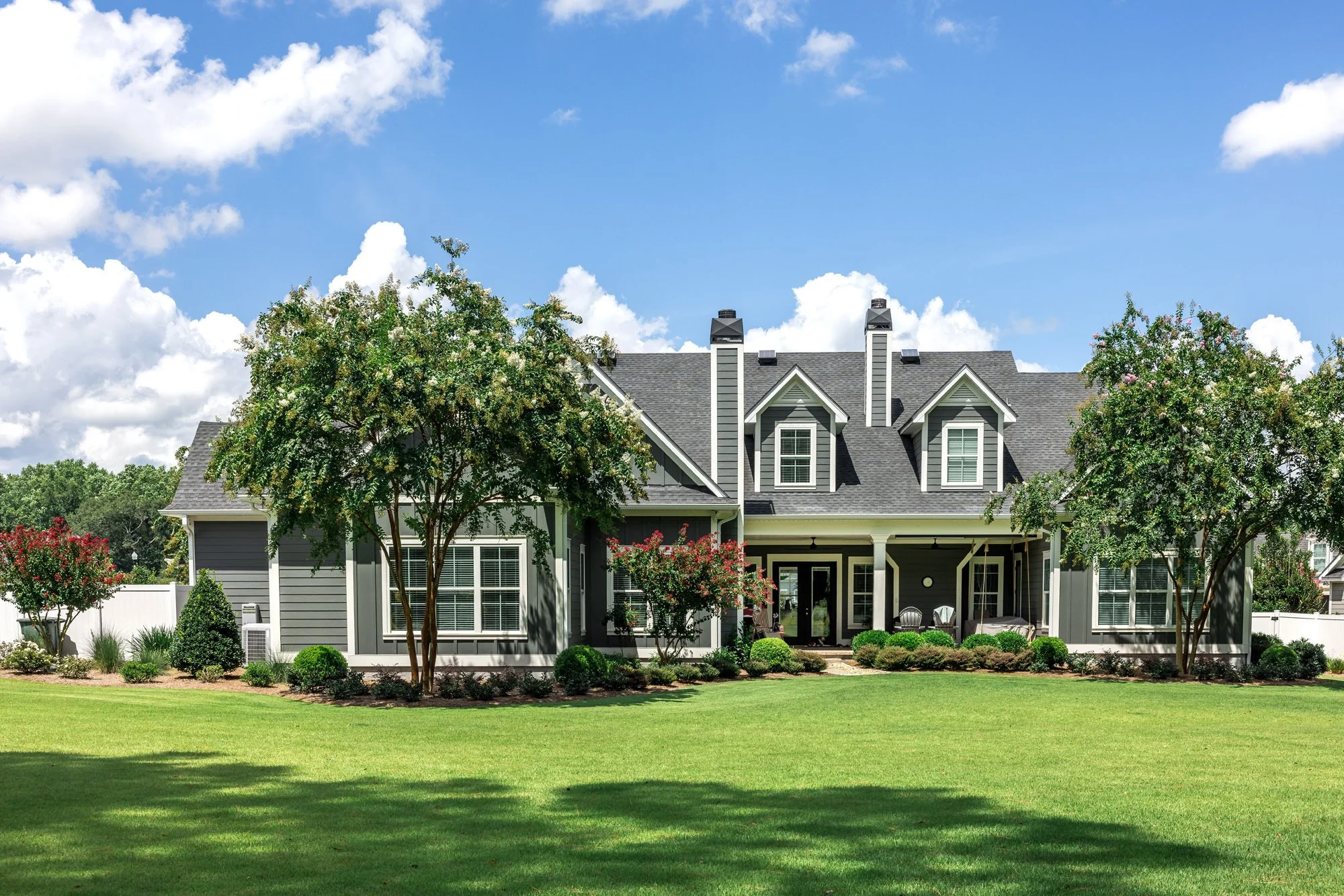 perfectly manicured lawn and gray home