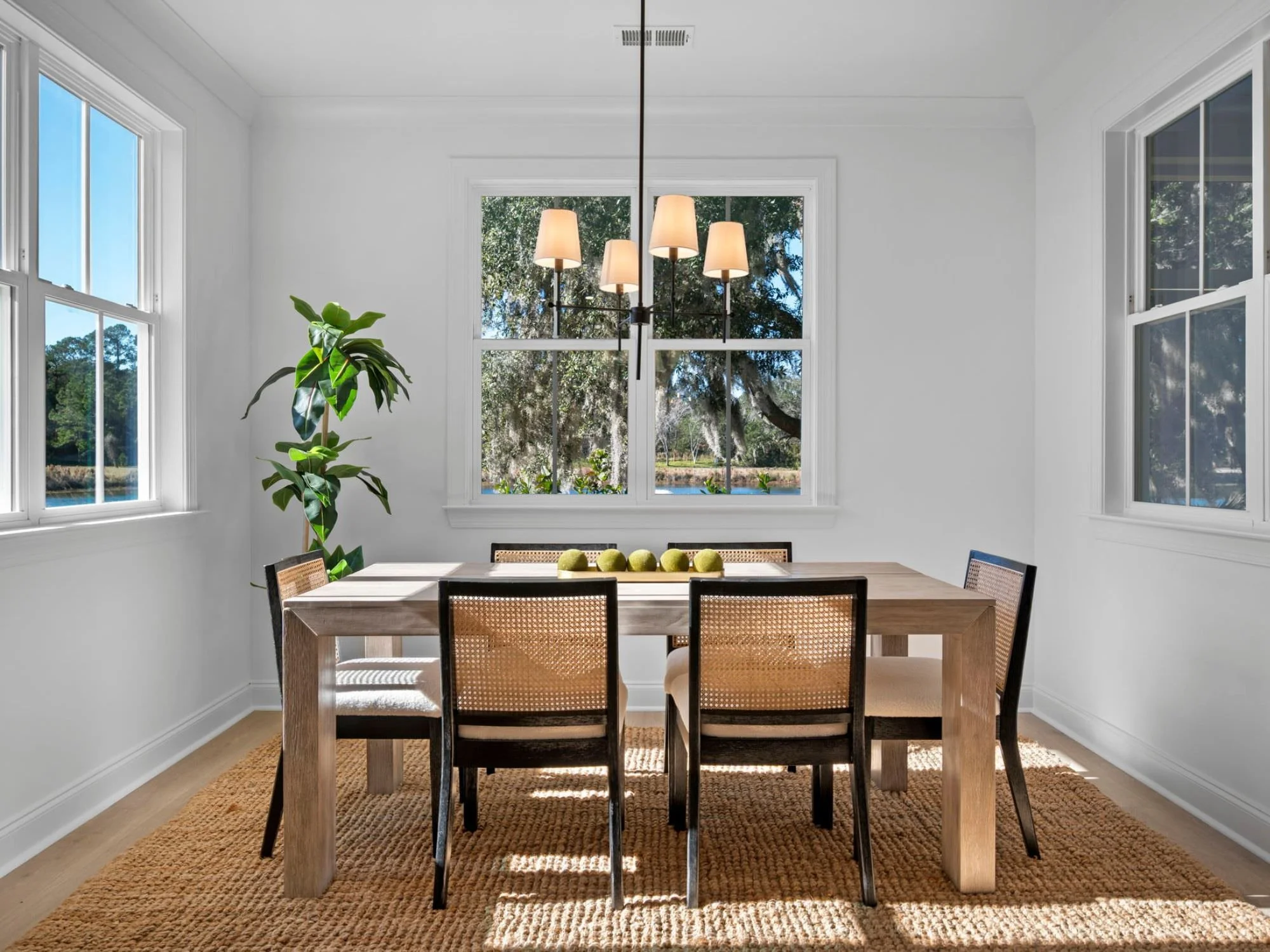 gorgeous wood table and rattan chairs - staging a dining room