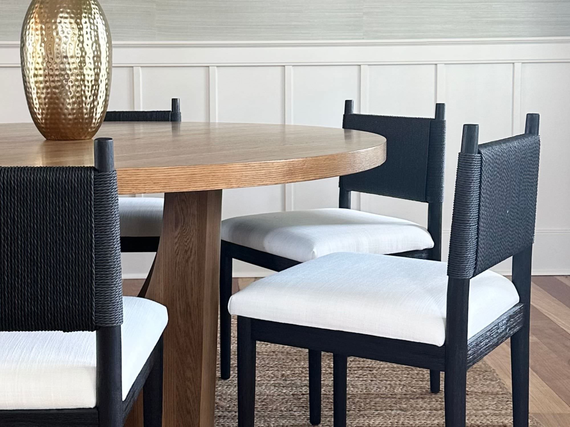 wooden table and black rattan chairs - staging a dining room