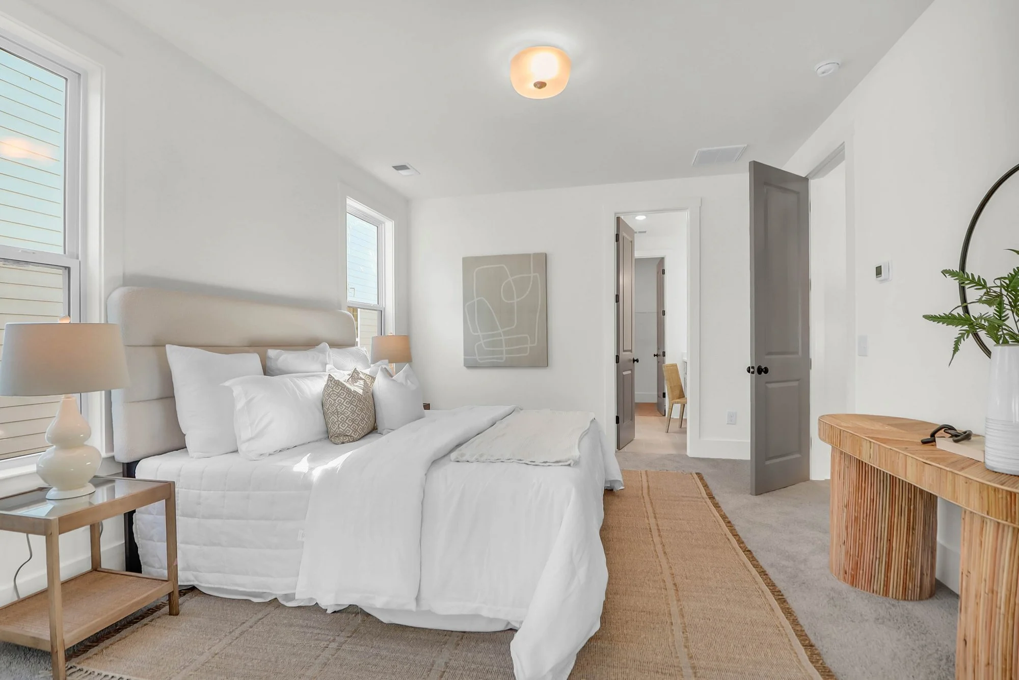 bedroom with comfy bedding, console tables and nightstands