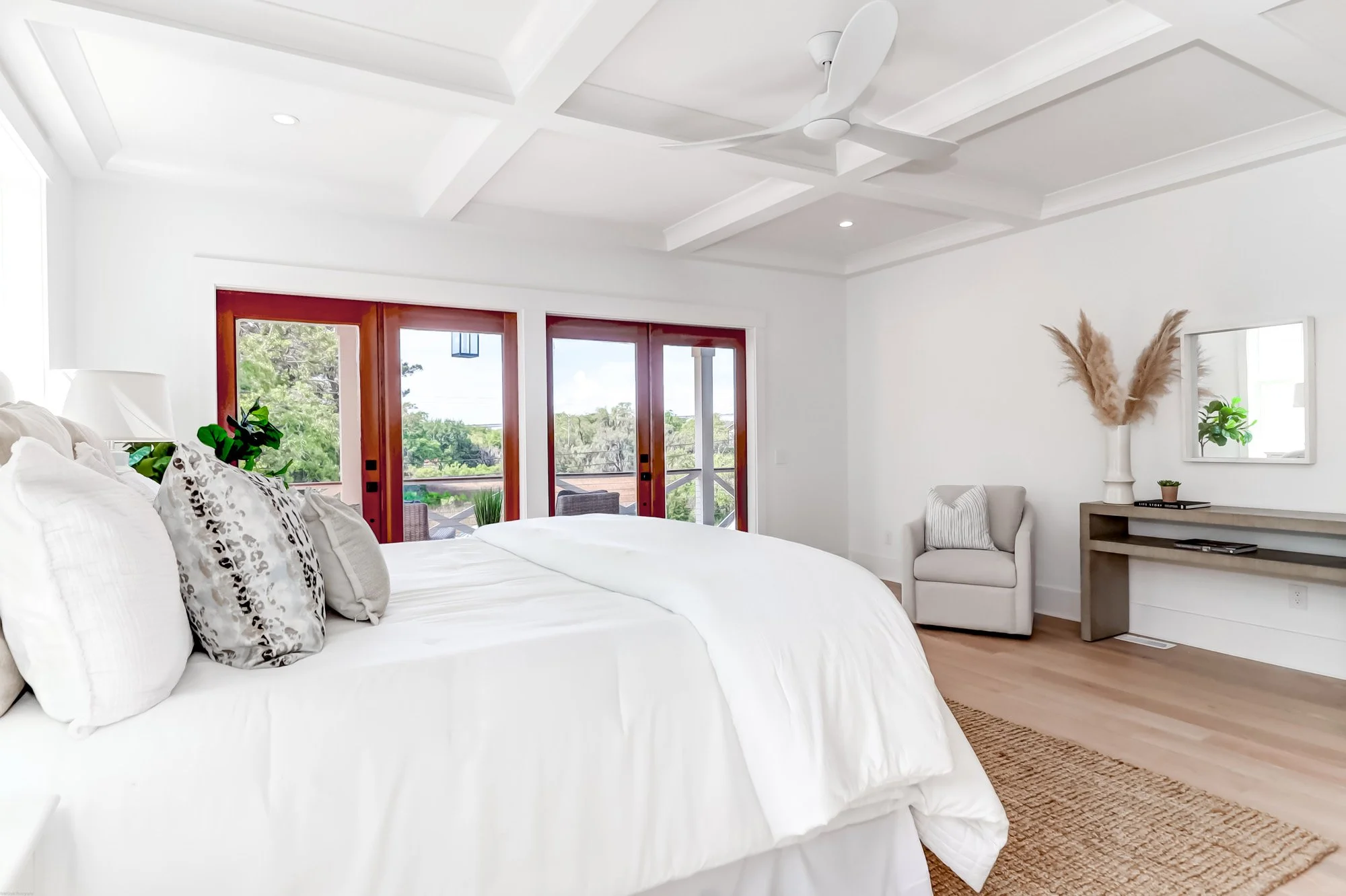 wide open bedroom with doors leading outside