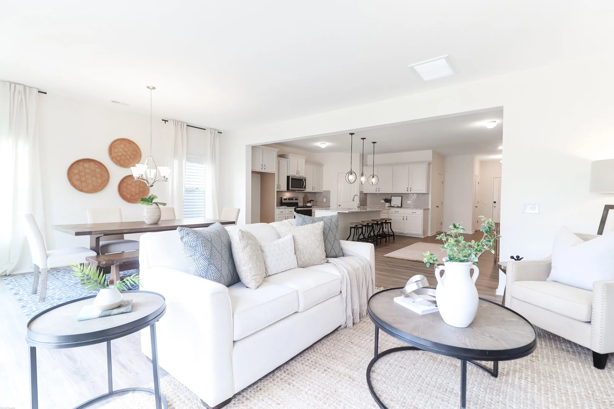 small room with couch, coffee table, side table and chairs