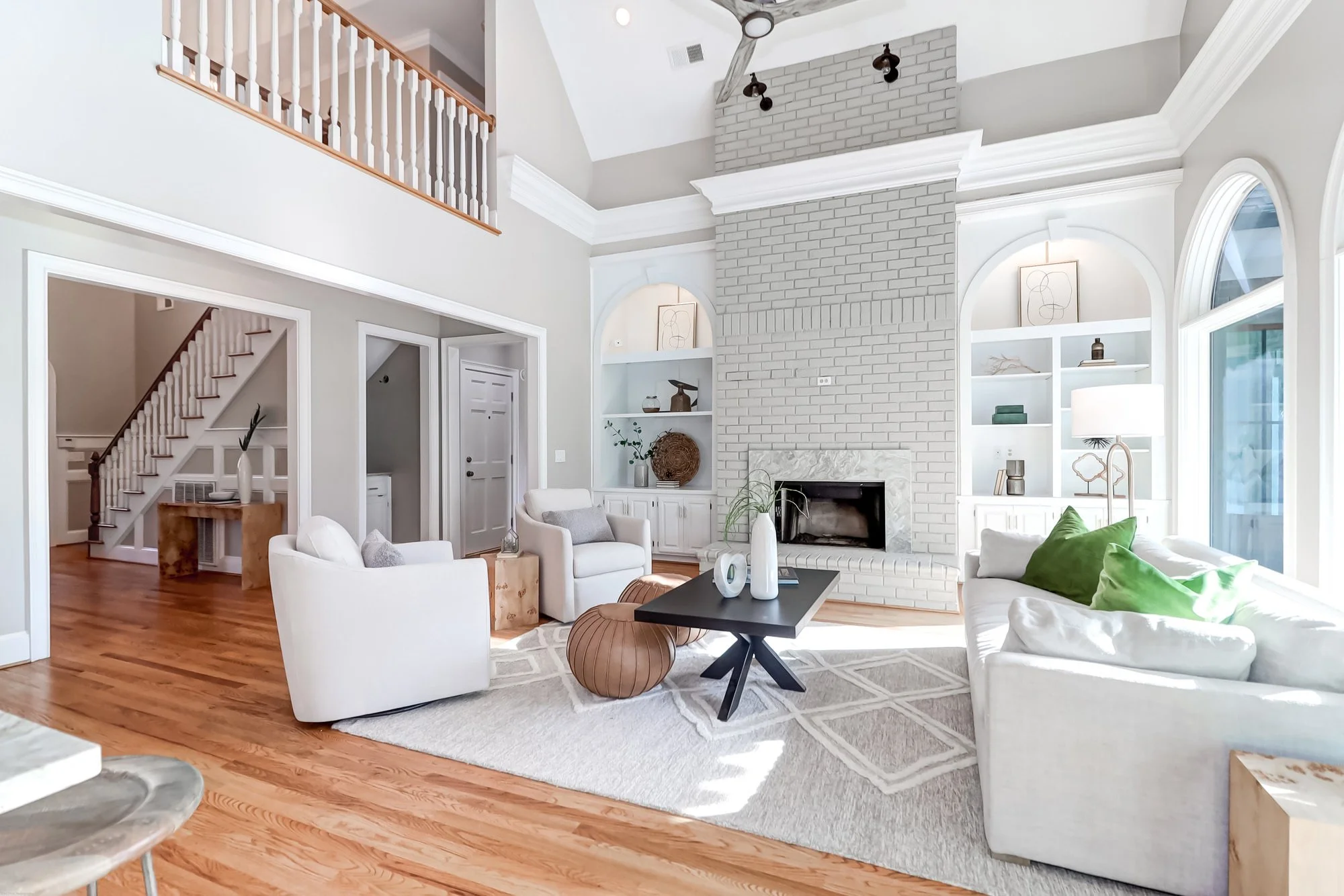 large optn room with chairs, side tables and styled bookshelves - living room staging charleston