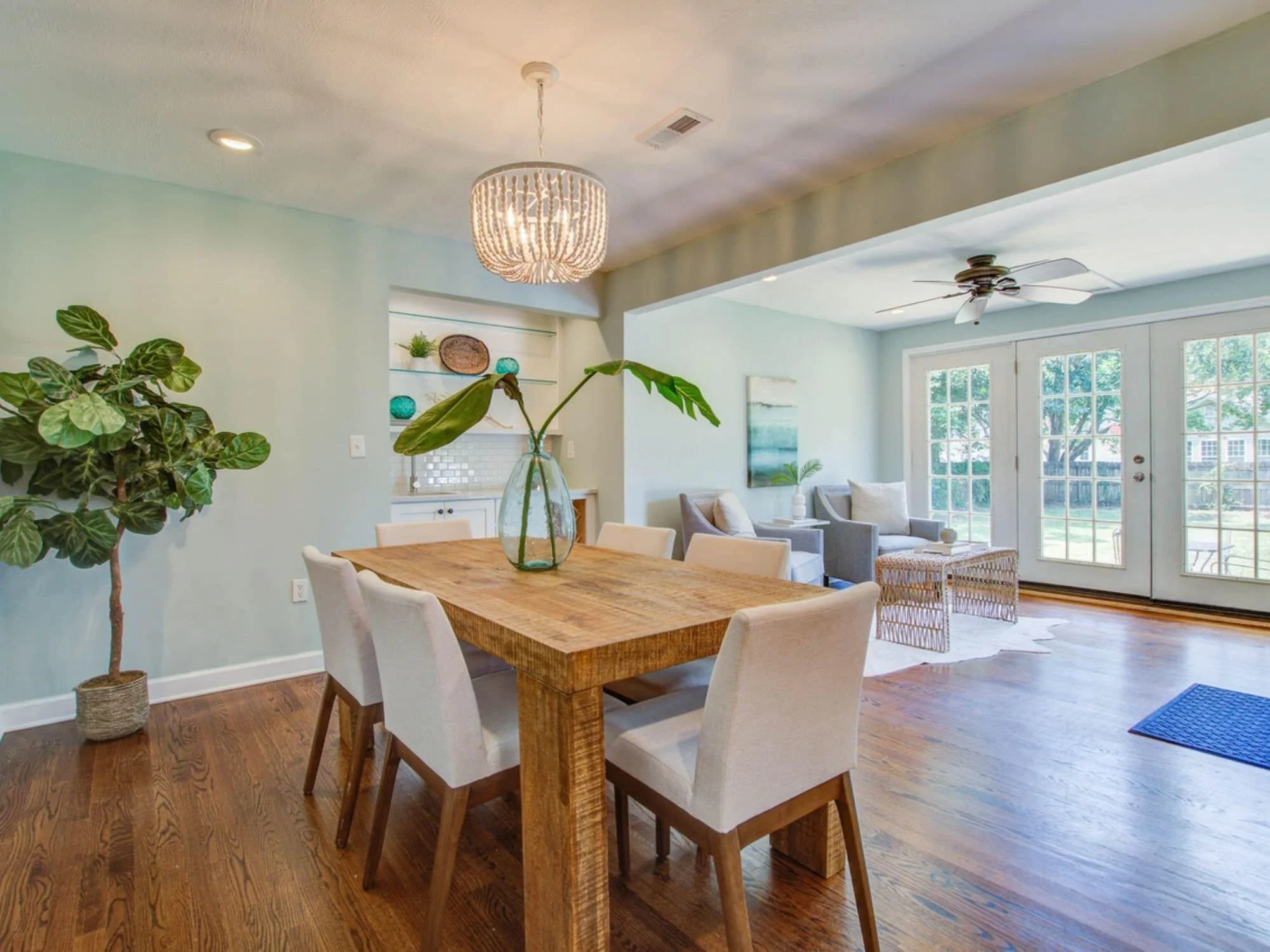 wooden dining room table and chairs in open room floorplan