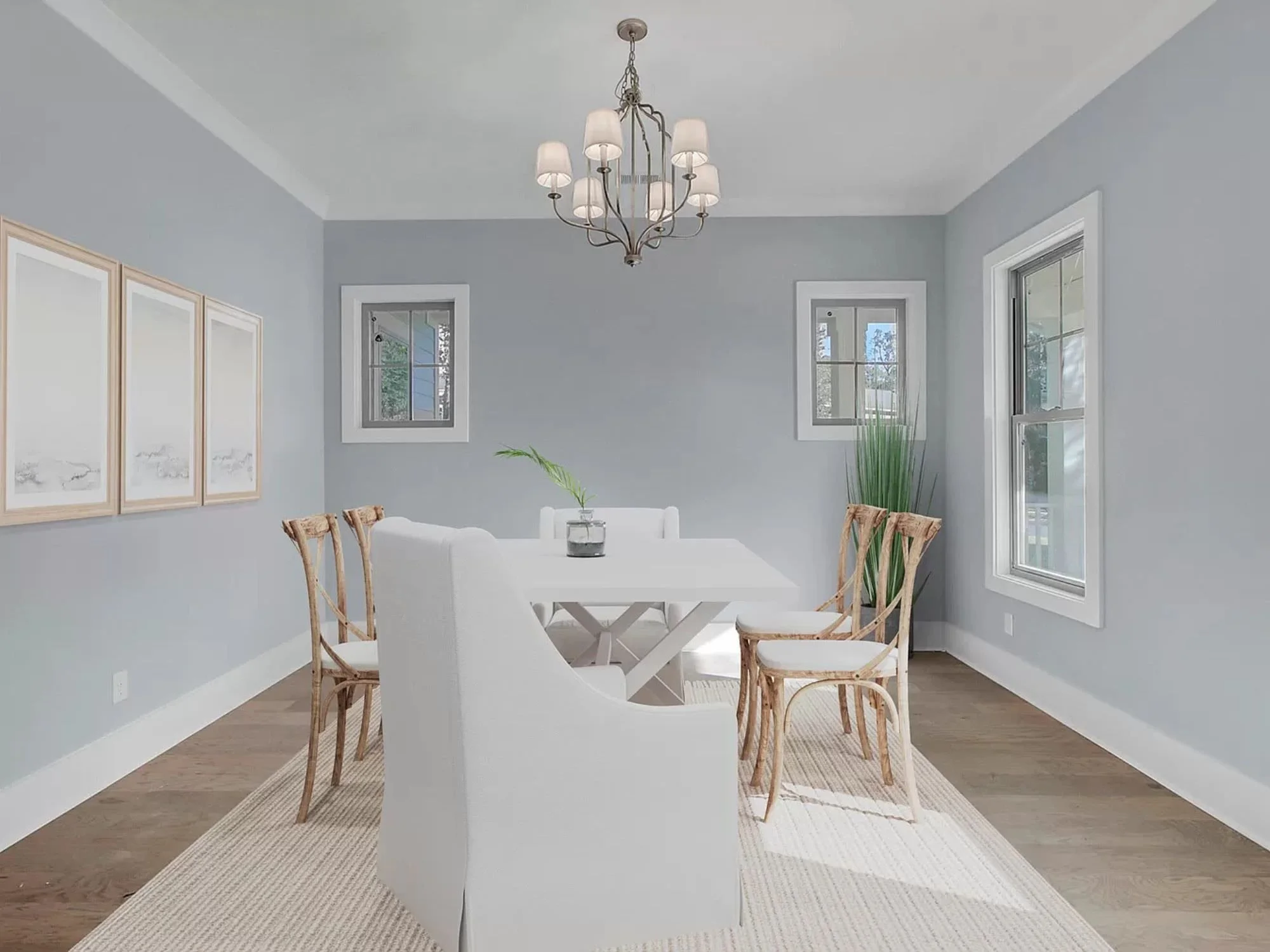 light blue room with artwork and dining table with matching chairs - staging a dining room