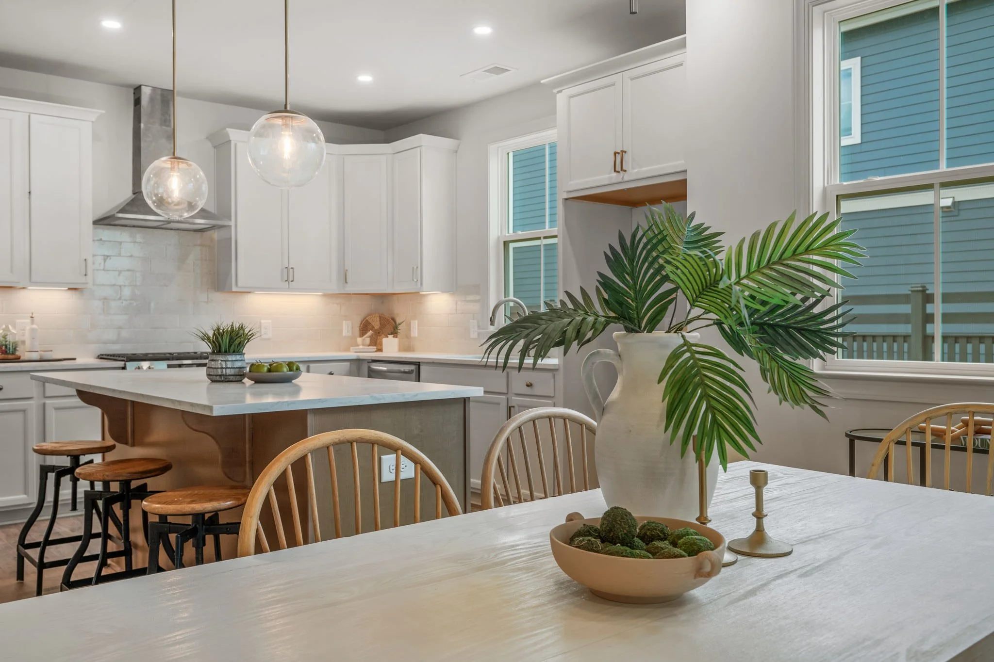 bar stools in open kitchen and kitchen table and chars - home staging cost