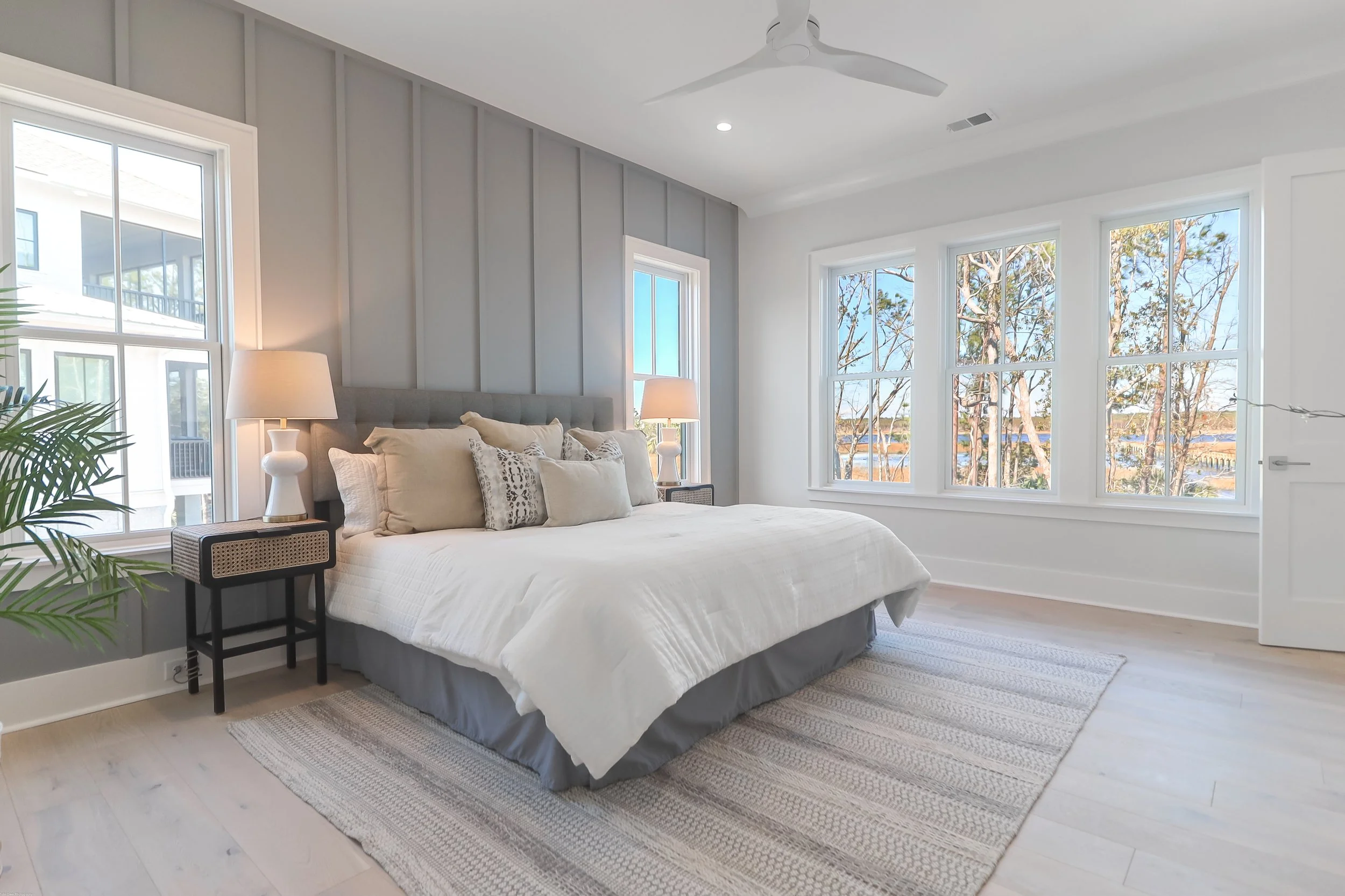 big bed and nightstands in bedroom overlooking the marsh