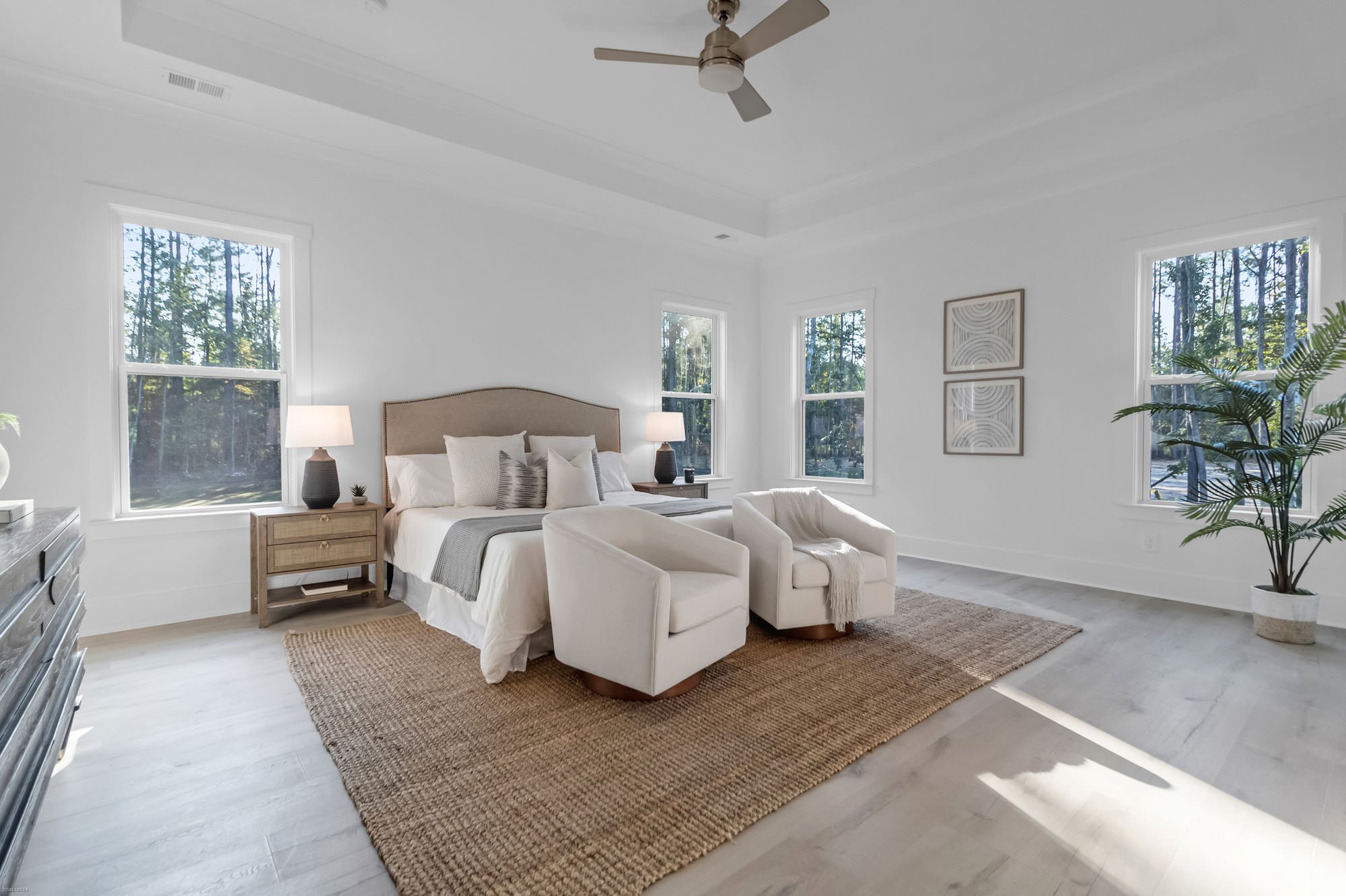 primary bedroom with chairs - home staging mistakes