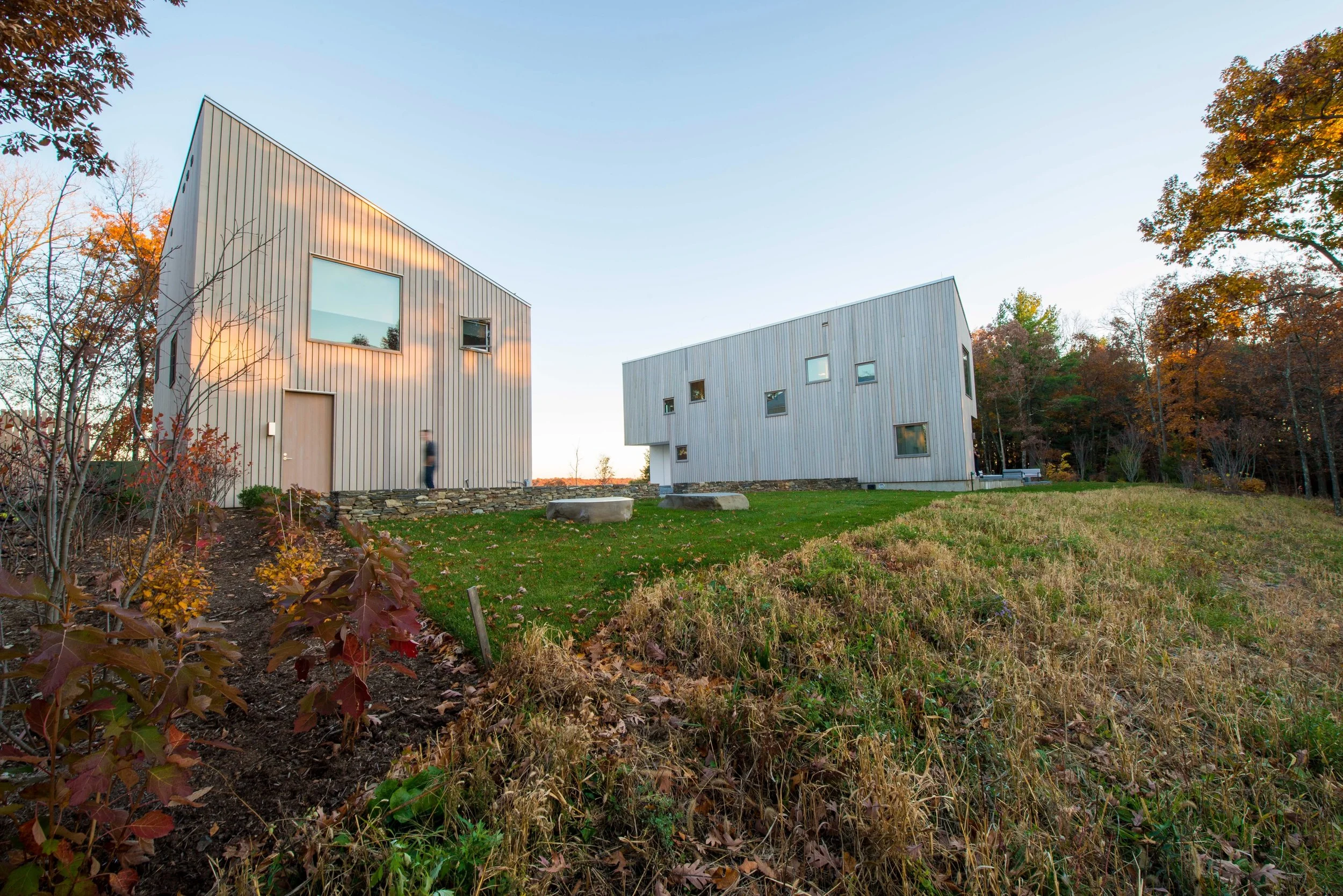 Completed Hudson River Valley House project.

The angular profile of the structures&rsquo; roofs mimic the silhouette of the mountains beyond. 
Custom-profile western red cedar siding boards set vertically create a serrated facade whose shadows chang