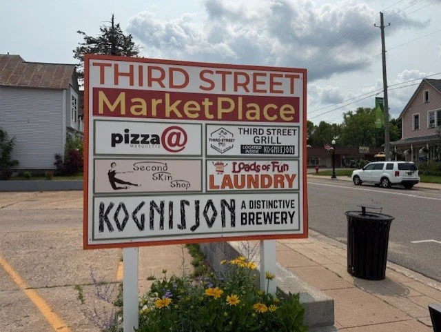 Business signs for the Third Street Marketplace.