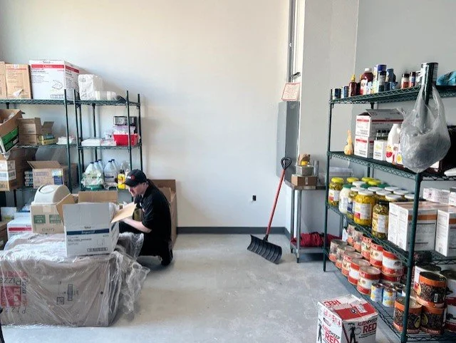 Back room with shelving for dry goods and jars.