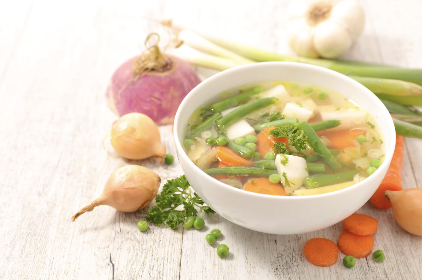 bowl of fresh vegetable soup in light broth