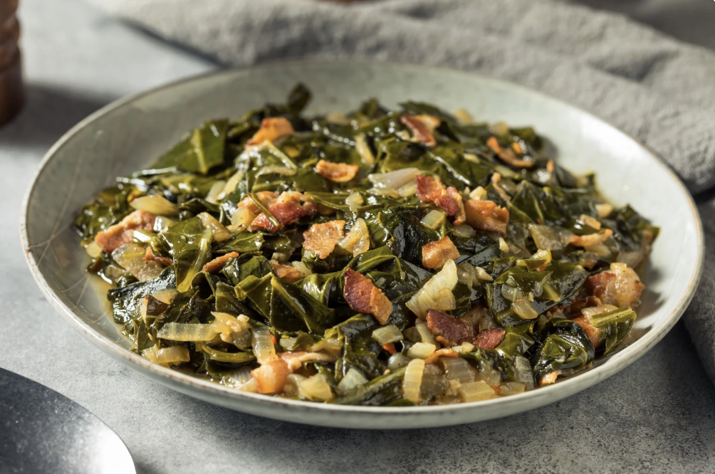 sauteed greens and onions in white bowl on table