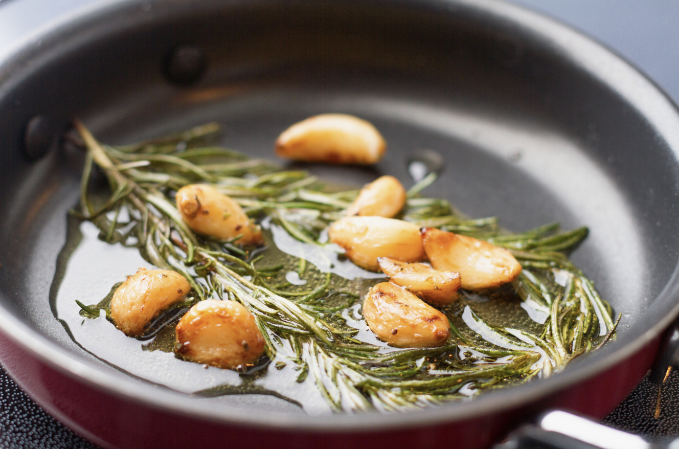 garlic with rosemary and olive oil in saute pan
