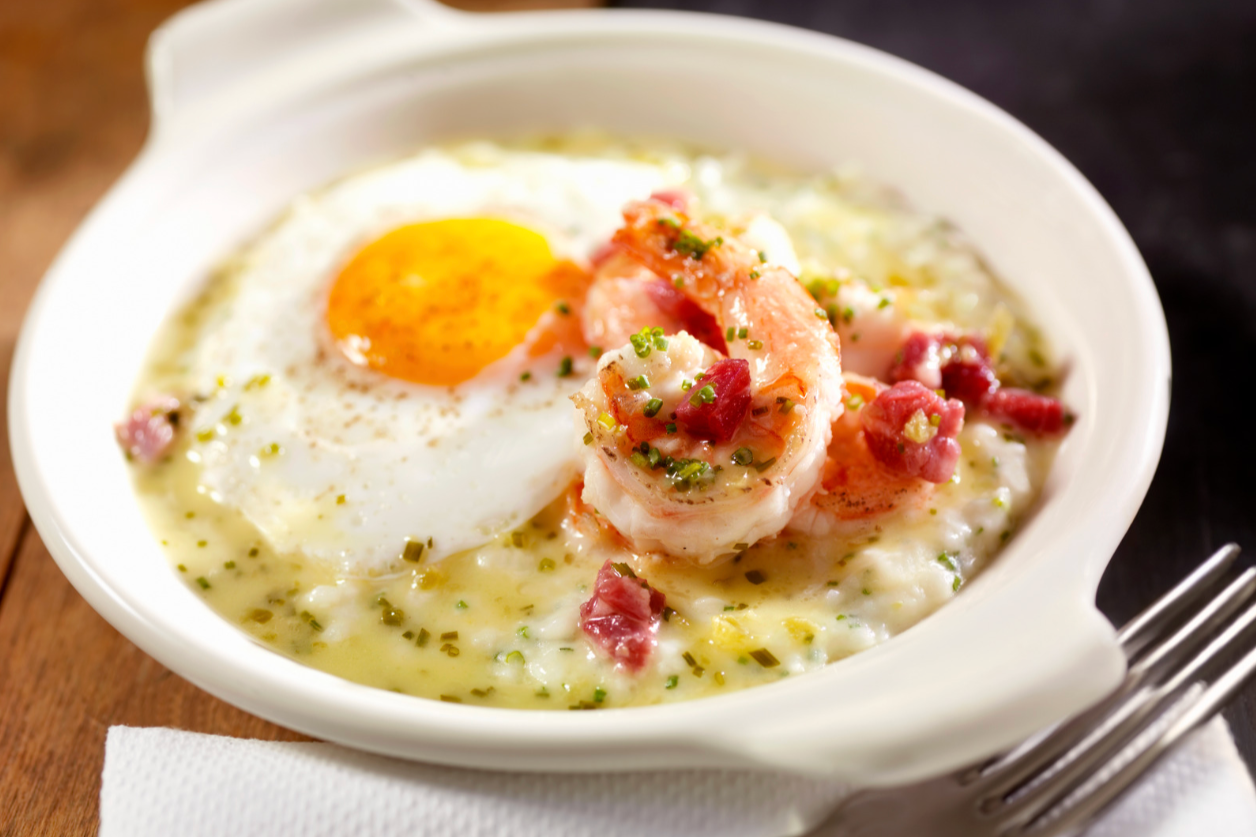 bowl of shrimp and grits with sunny-side-up fried egg