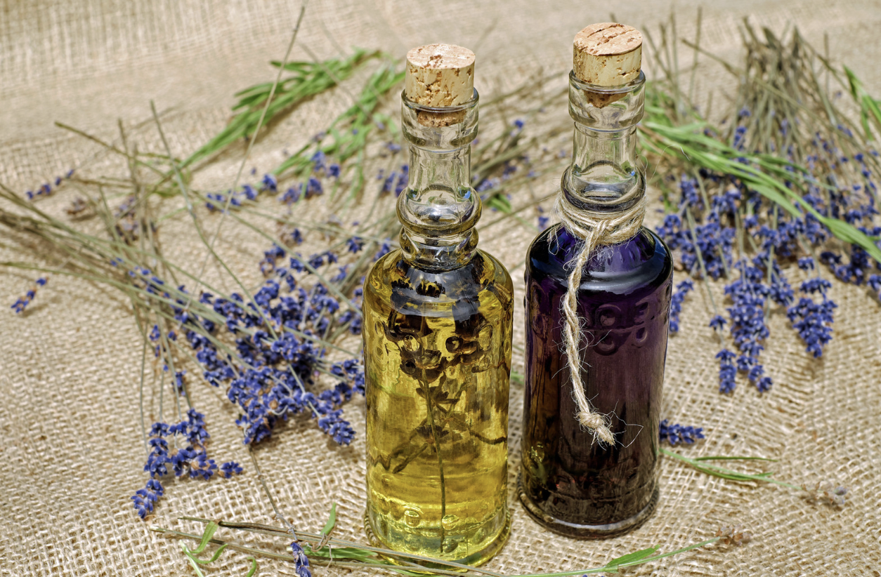 glass bottles of lavender in oil on burlap
