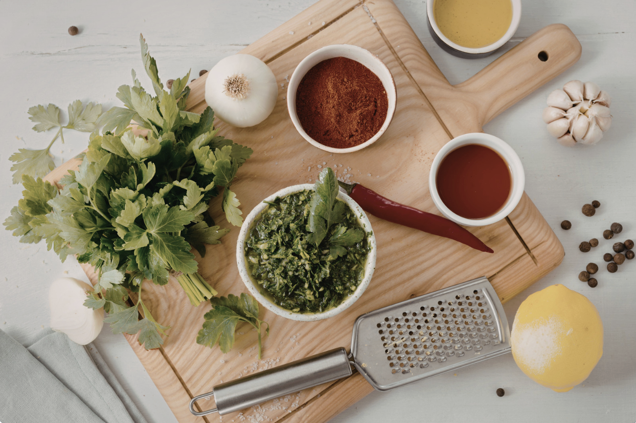 herbs and spices with lemon on wooden cutting board