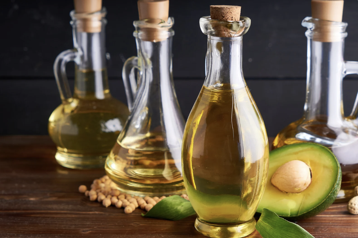 multiple clear glass bottles of various plant oils