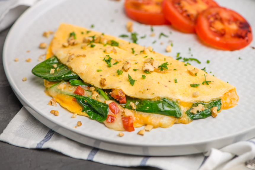 healthy omelet filled with tomato, spinach and cheese