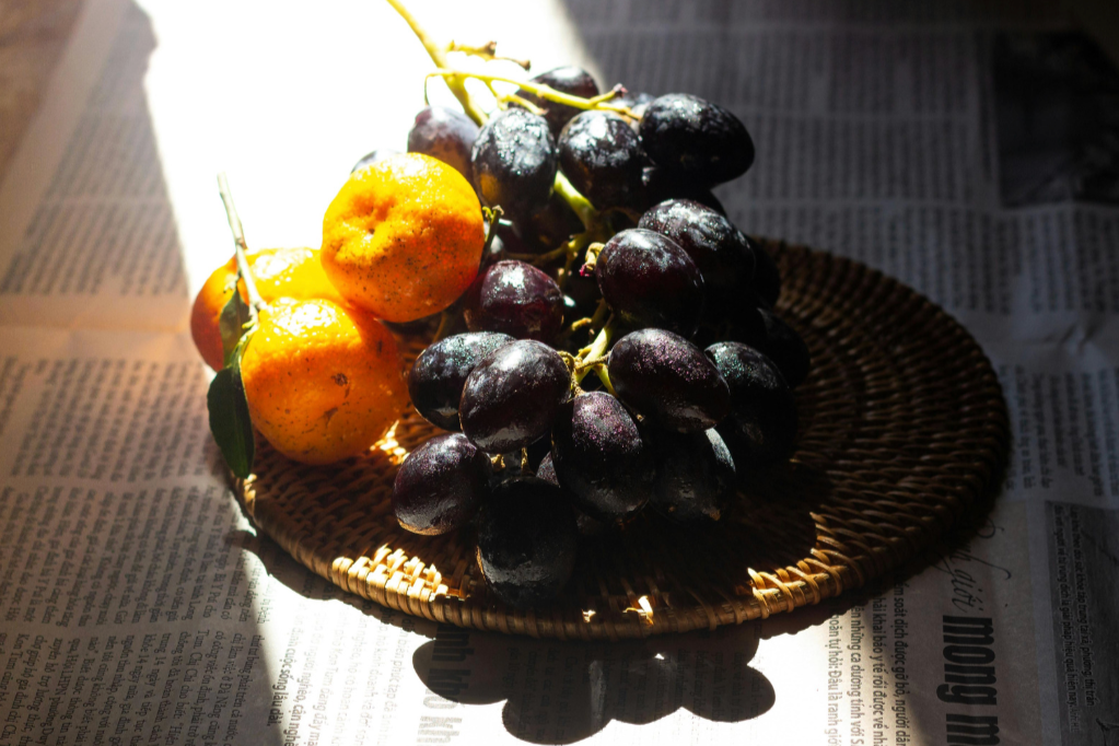 kumquats and red grapes in morning light