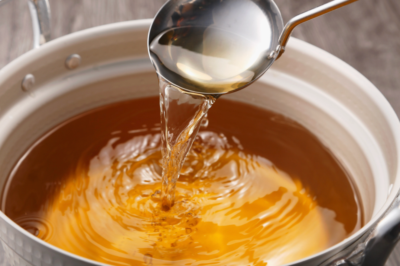 mushroom broth in bowl with ladle