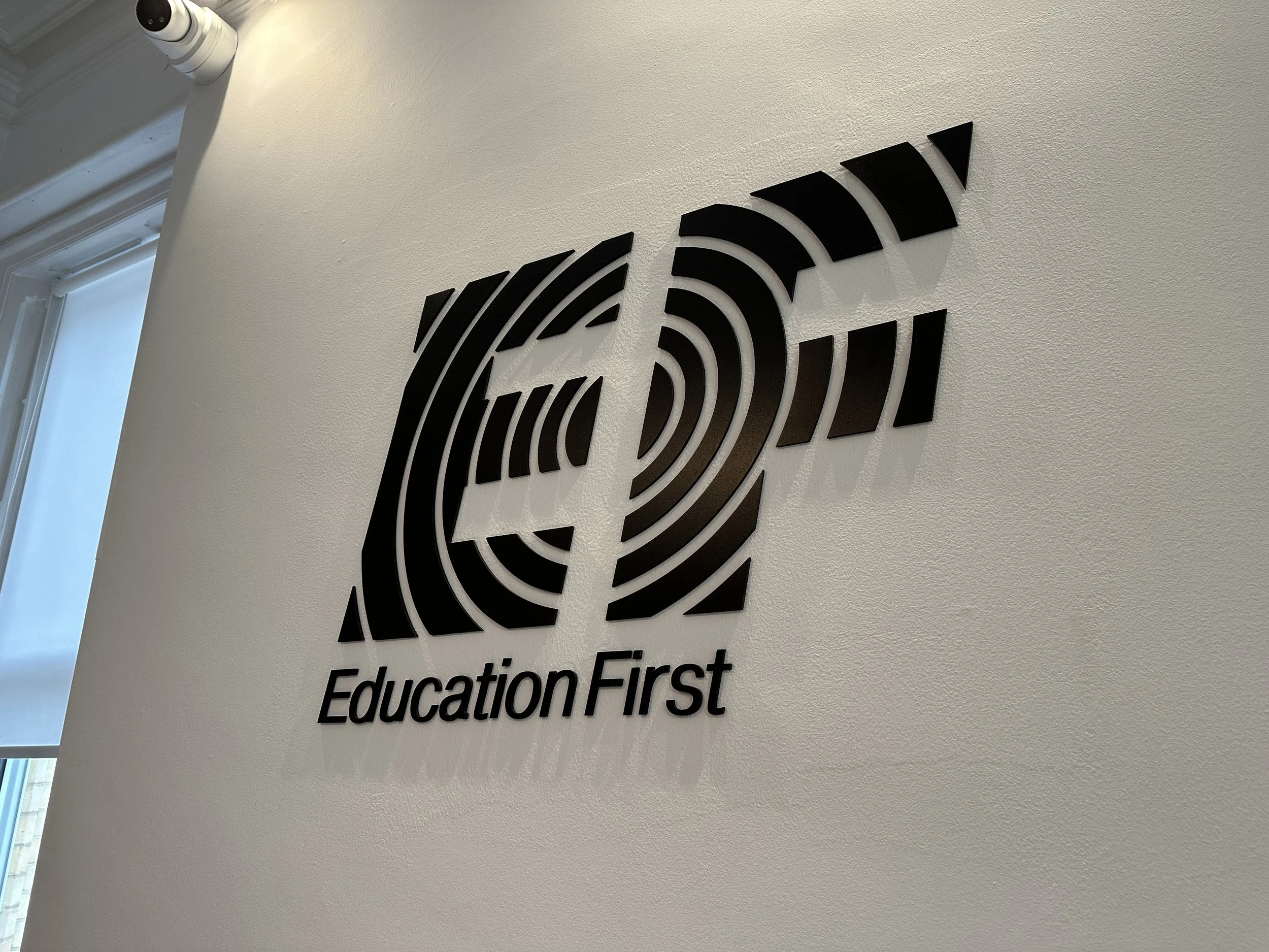  Acrylic flat cut letters, installed using PVC Locator Fixings at EF Language School. 