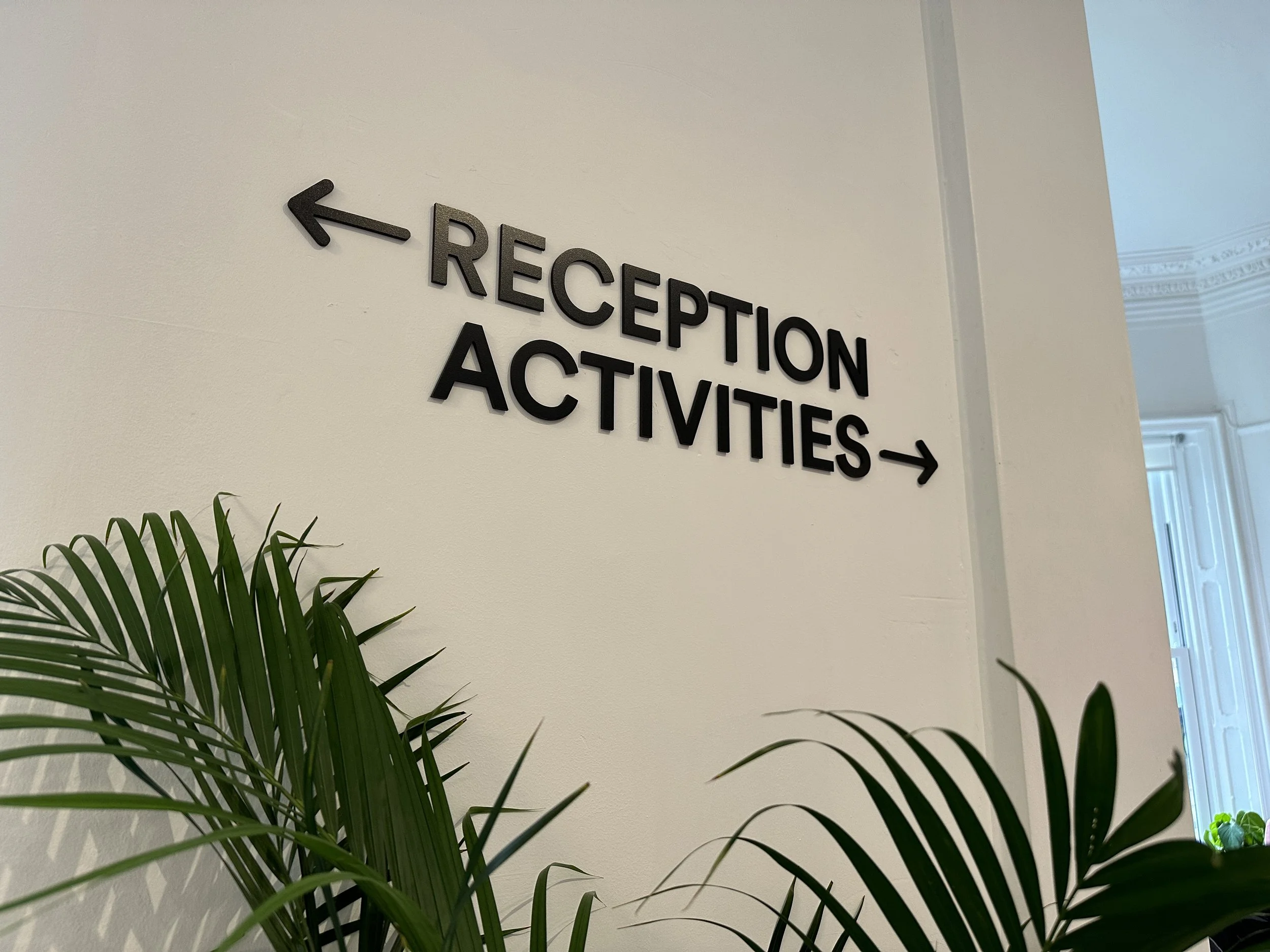  Wayfinding directional flat cut acrylic letters installed at EF Language School 