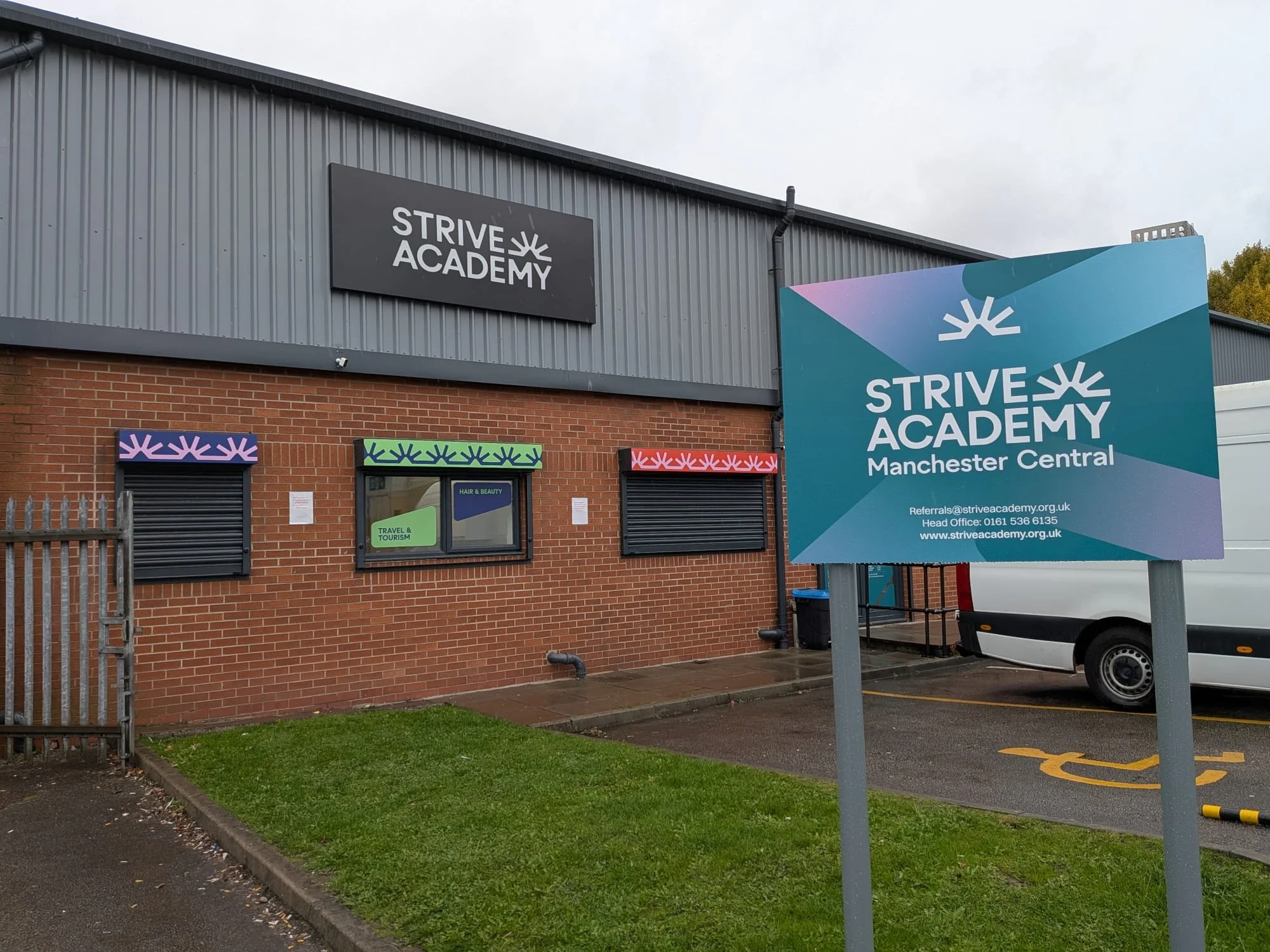 School entrance post and panel signage at Strive Academy Manchester Central