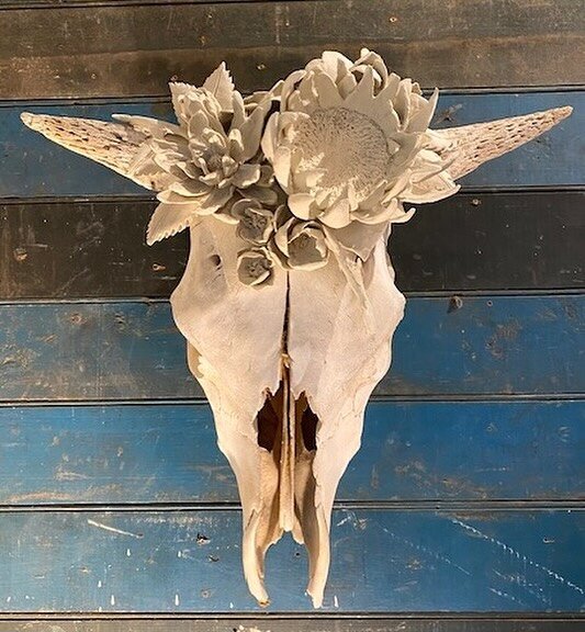 Marcy Lally adorns animal skulls with sculpted flowers from a variety of colored earthen clays.  She presses each petal by hand.  Her work represents a unique time capsule celebrating the intricacies in the cycle of life; life emerging from decay.  M