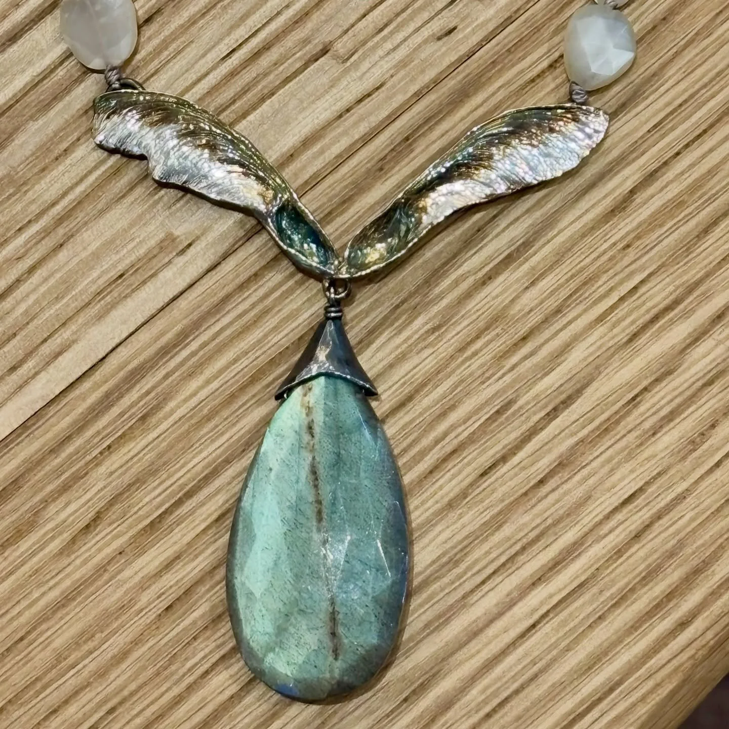 Artisan Jeweler Kristi Hyde&rsquo;s latest piece is  simply gorgeous. A sterling maple seed pod in sterling, accented with moonstones and white topaz. Adjustable deerskin leather ties. Truly a statement piece yet so wearable. #kristihydejewelrydesign