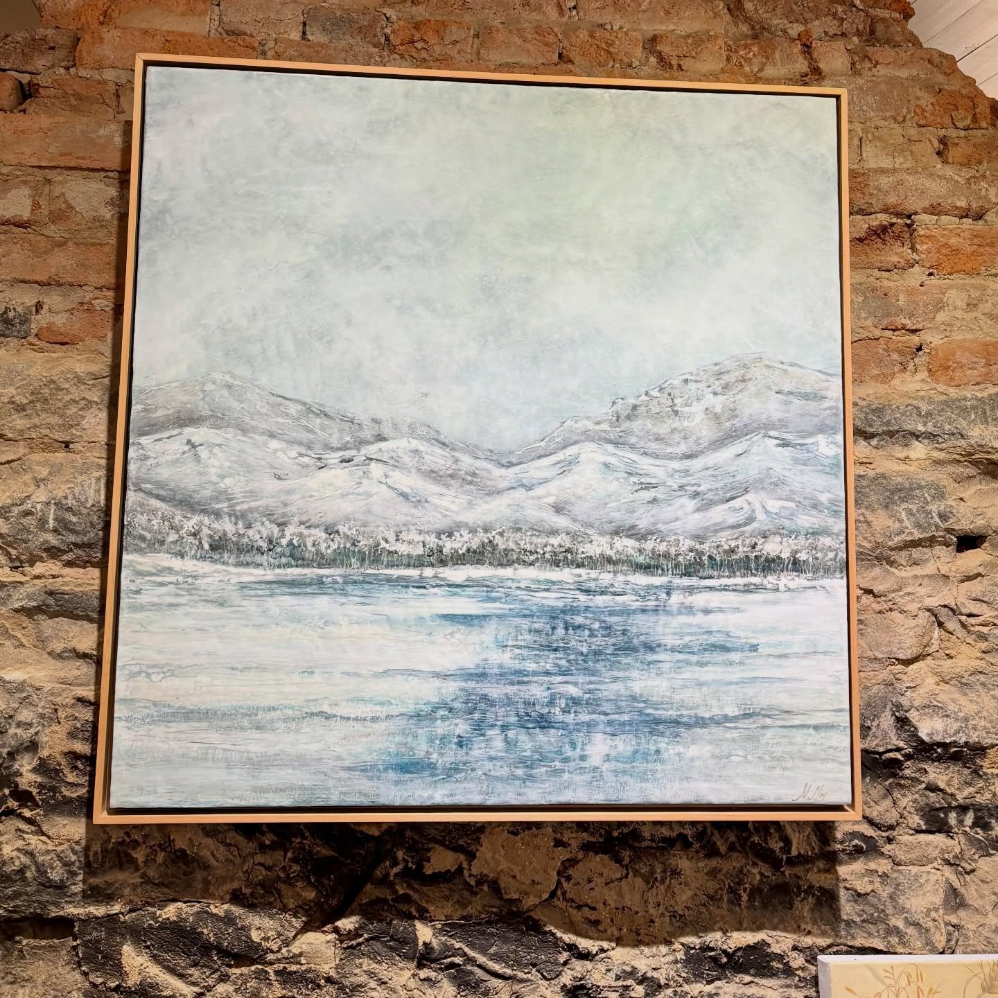 Lynne Miller&rsquo;s encaustic paintings are created with pigmented wax on a wood panel and fused through the use of a heated palette, mixing colors and layers.  She lets the play of light and layering represent the shadowy hills in the distance and 