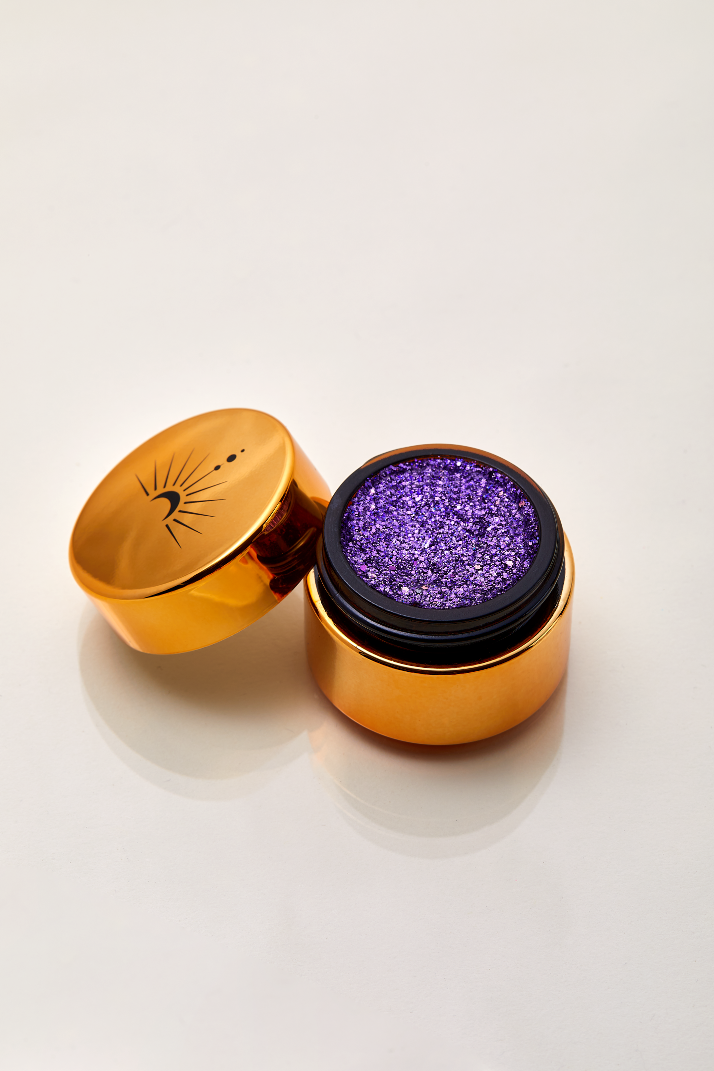 Sparkling violet purple shimmering with pink and silver  highlights of plant based glitter cream in a vegan and non toxic formula dries to a water resistant powder finish