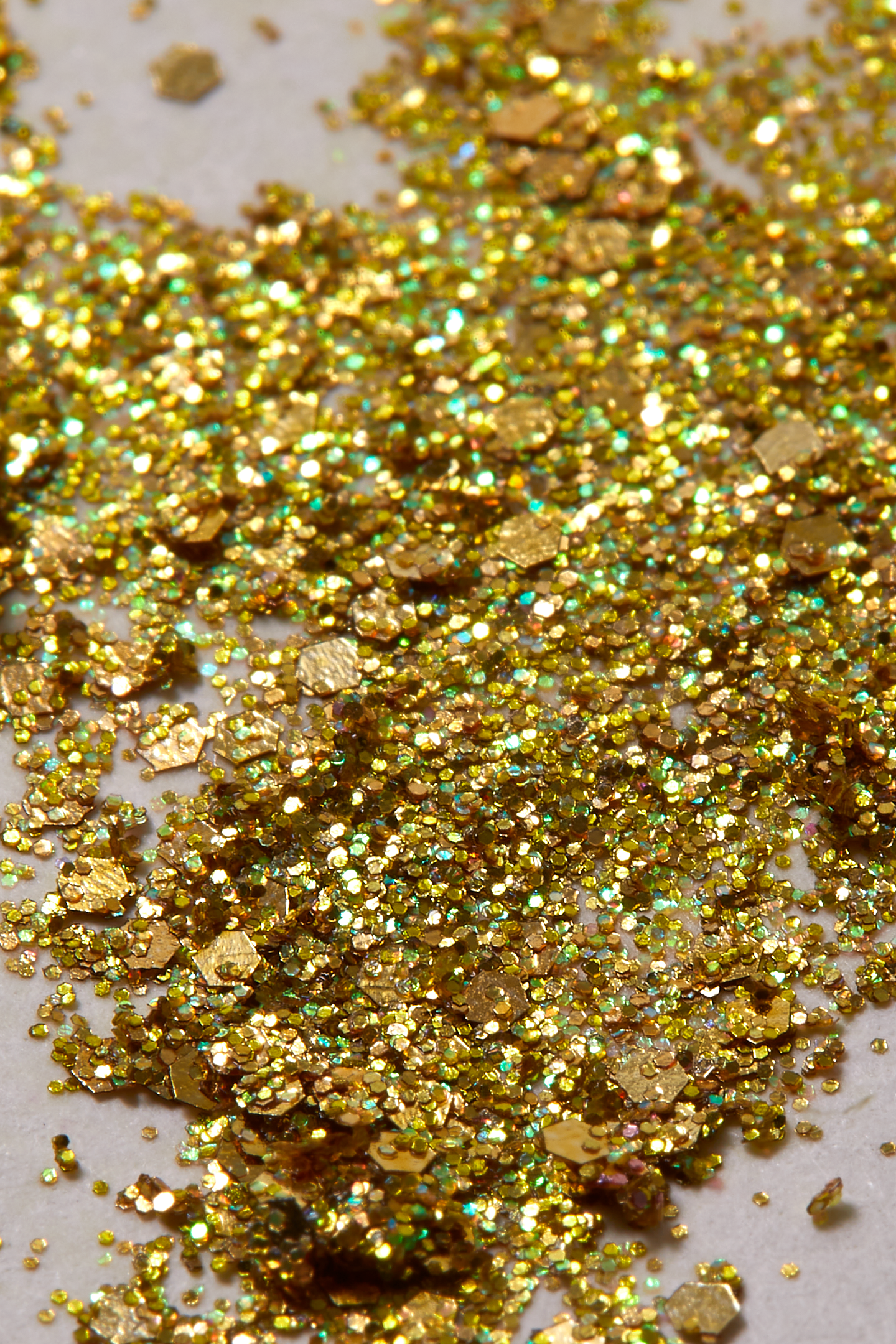 Shimmering Solid gold with iridescent sparkle of plant based glitter cream in a vegan non toxic formula dries to a water resistant powder finish
