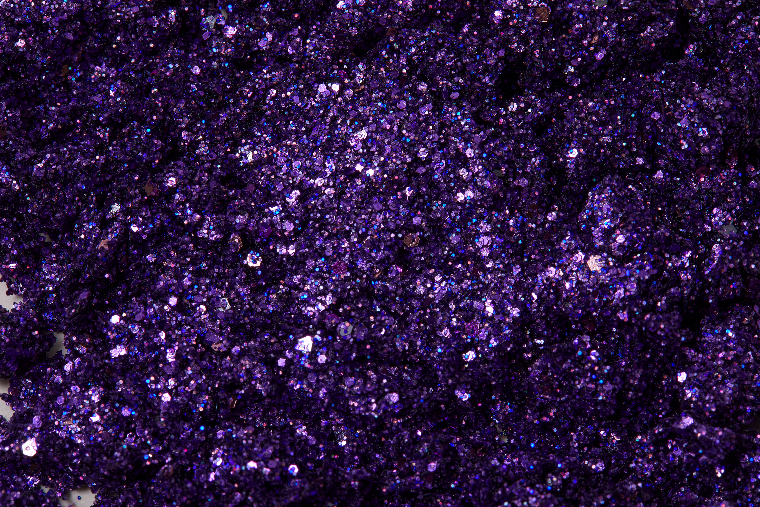 Sparkling violet purple shimmering with pink and silver  highlights of plant based glitter cream in a vegan and non toxic formula dries to a water resistant powder finish