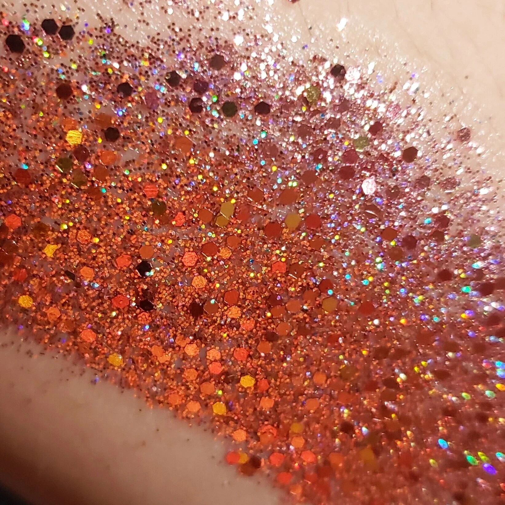 Shimmery rose gold sparkling plant based glitter cream in a vegan non toxic formula dries to a water resistant powder finish