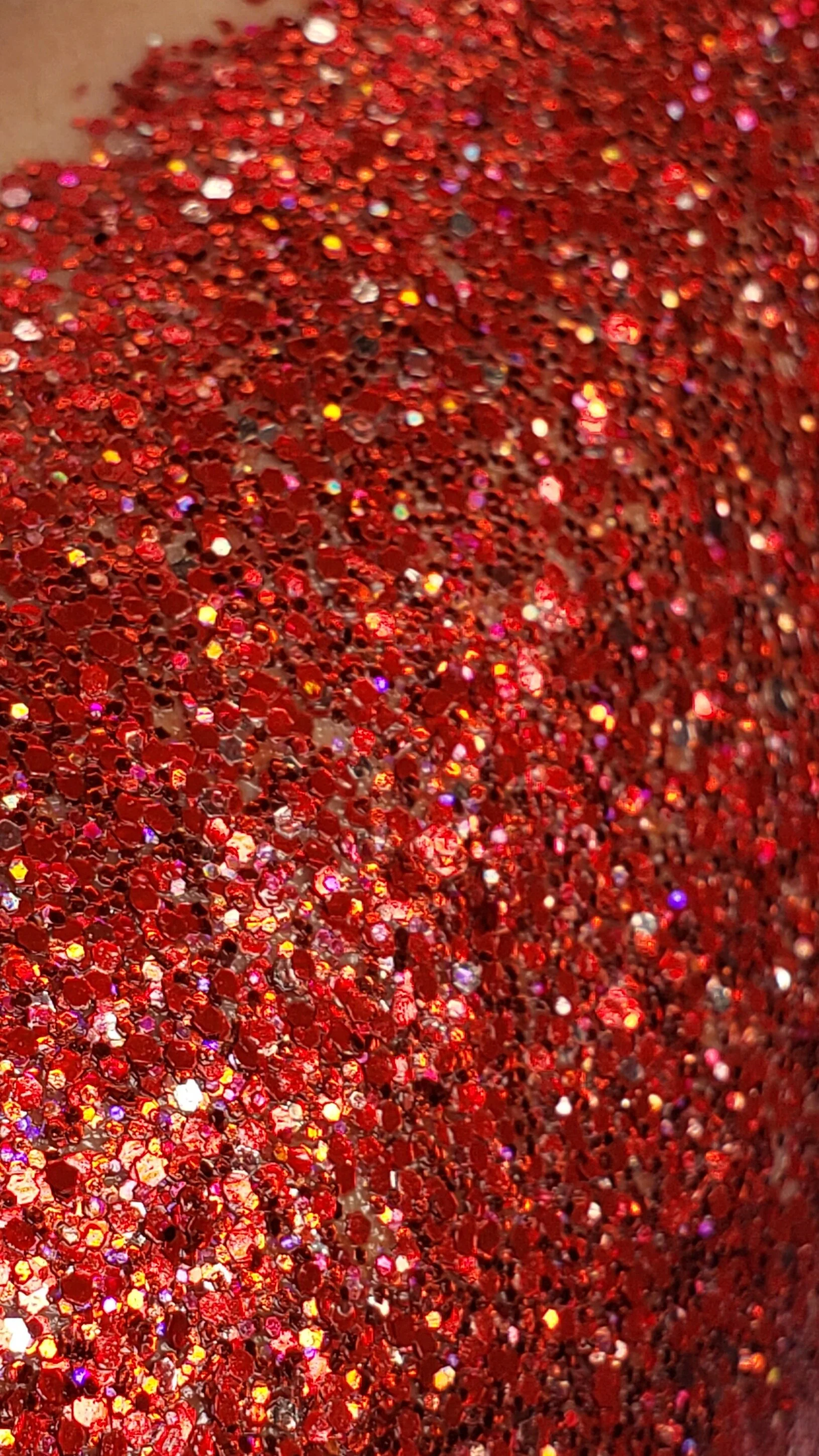 Rich ruby red shimmer with sparkling violet plant based glitter cream in a vegan and non toxic formula dries to a water resistant powder finish