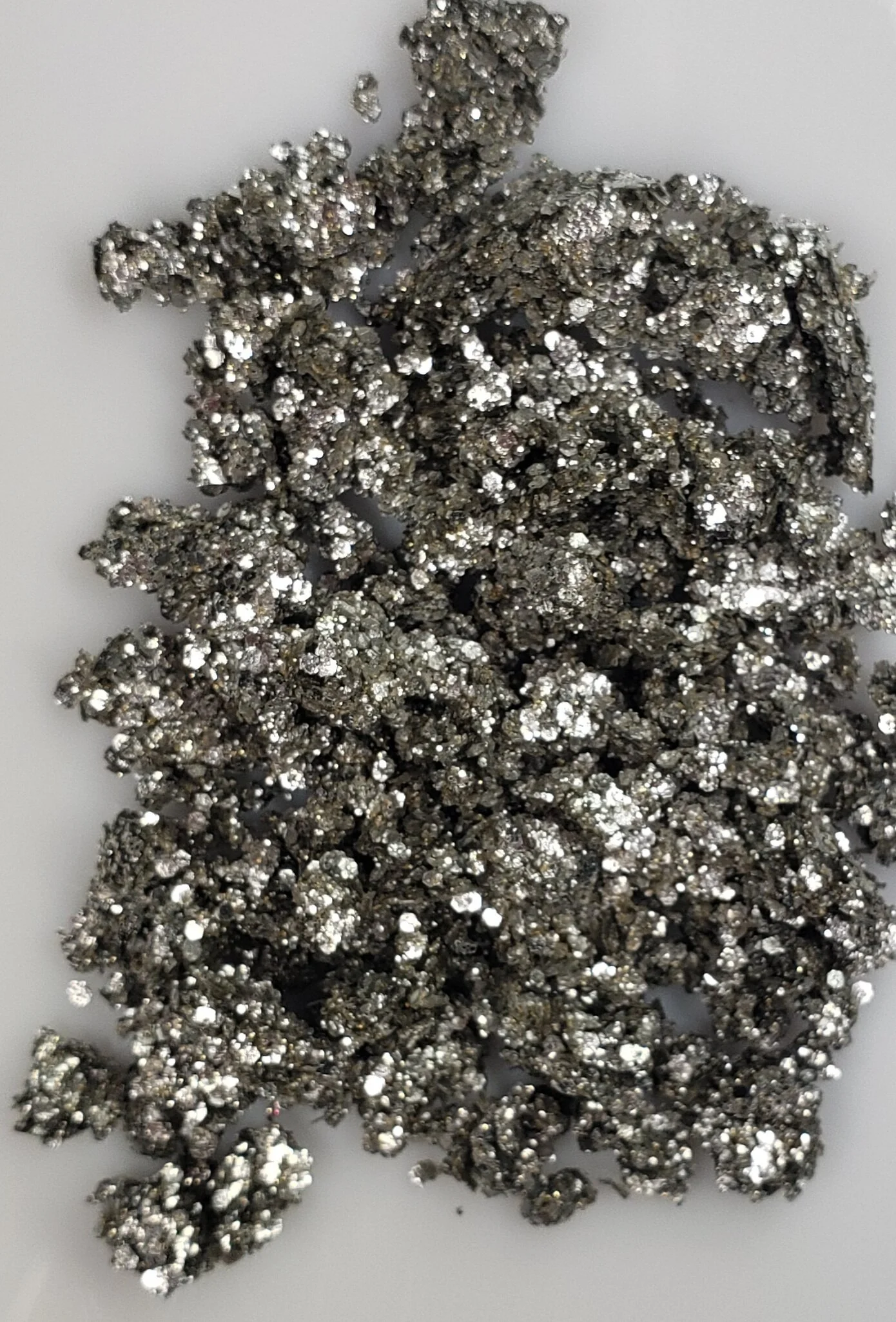 Sparkling champagne silver shimmering plant based glitter cream in a vegan and non toxic formula dries to a water resistant powder finish