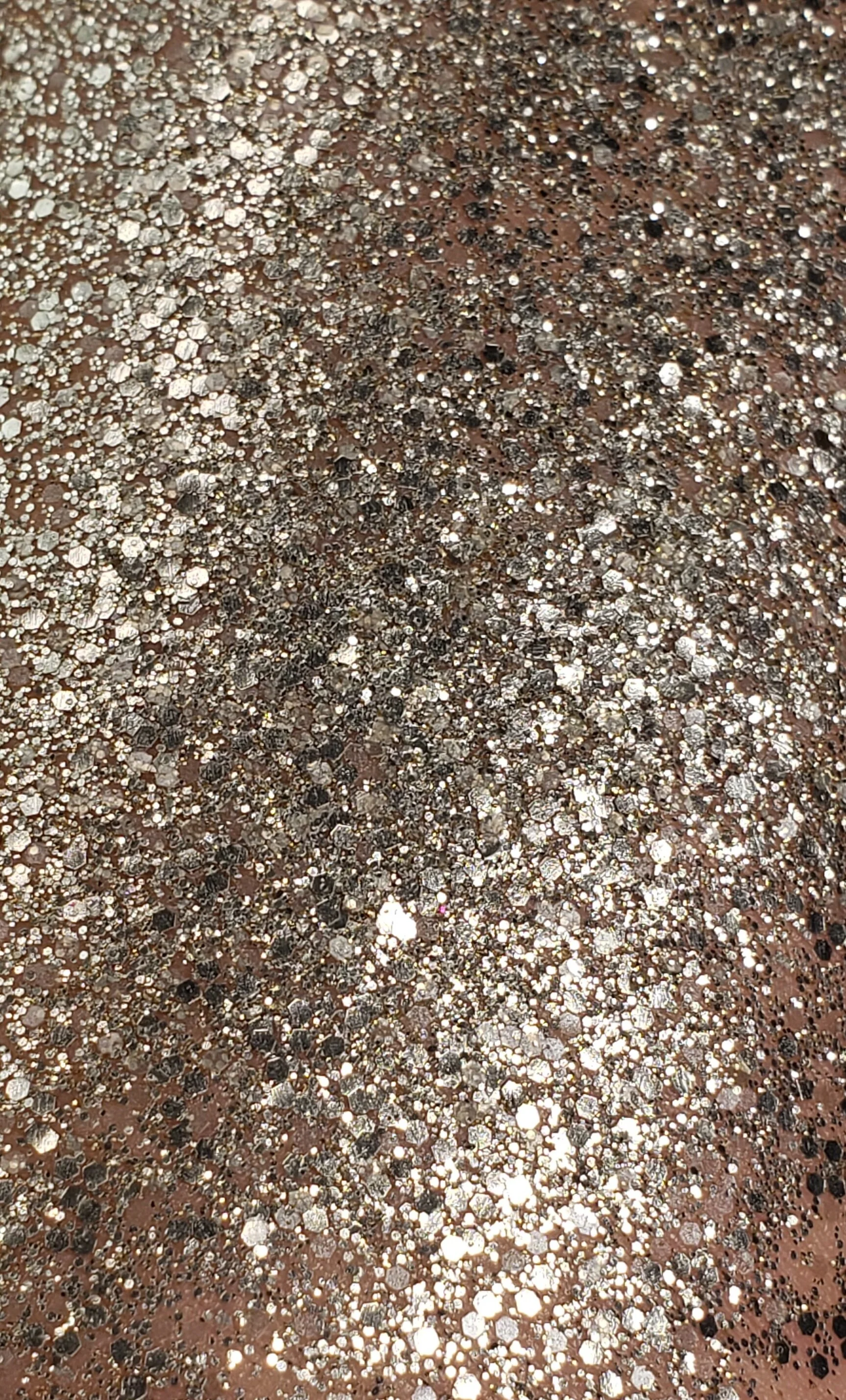 Sparkling champagne silver shimmering plant based glitter cream in a vegan and non toxic formula dries to a water resistant powder finish