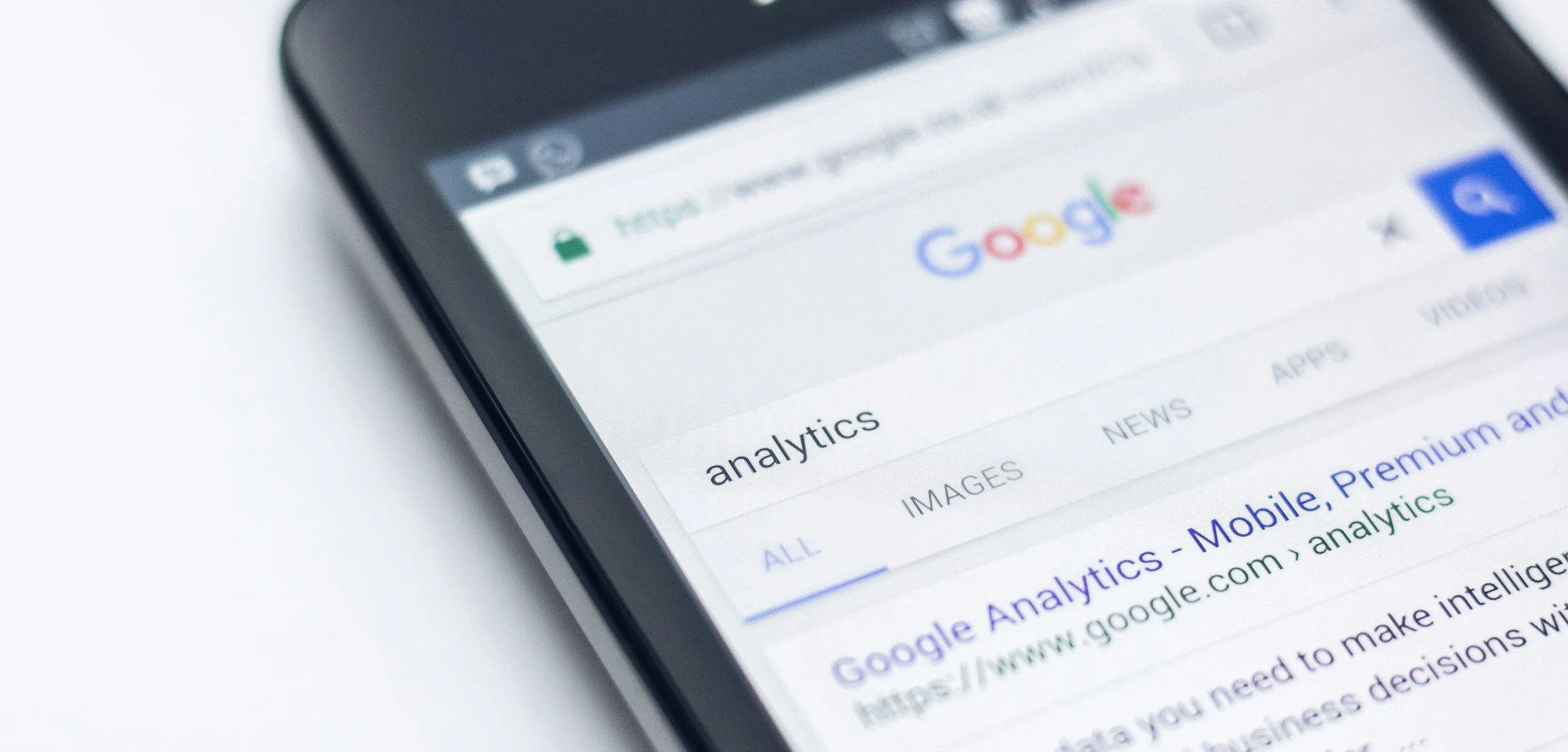 Close-up of a smartphone displaying a Google search results page with a focus on the 'Analytics' section.