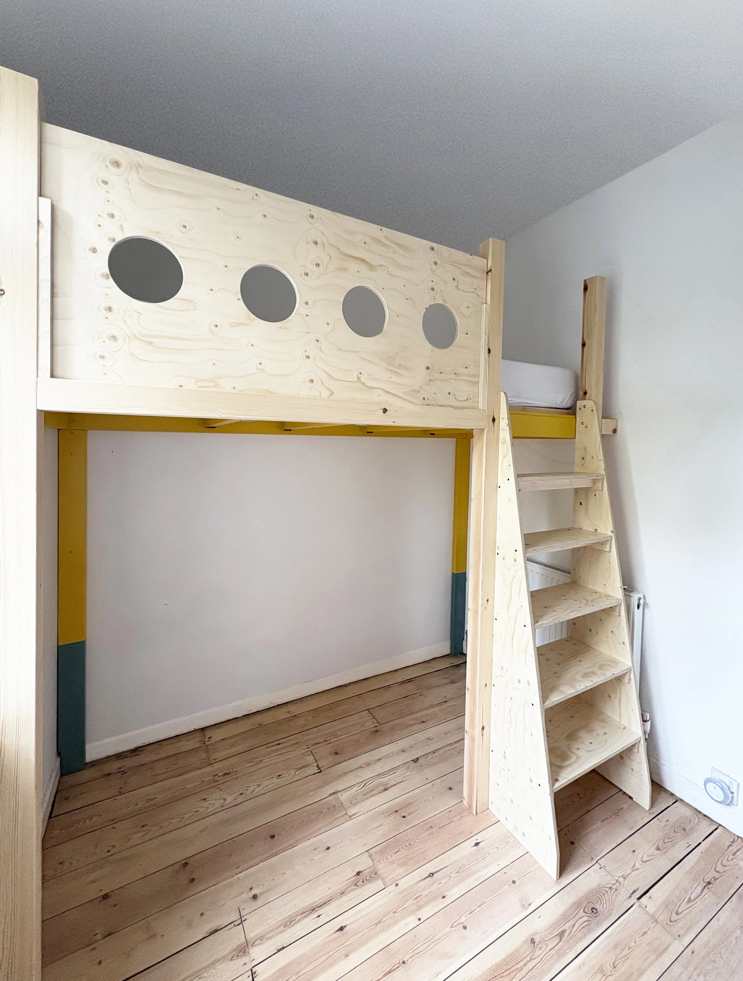 Kids loft bed with slide up front panel, so changing the sheets is easy peasy!