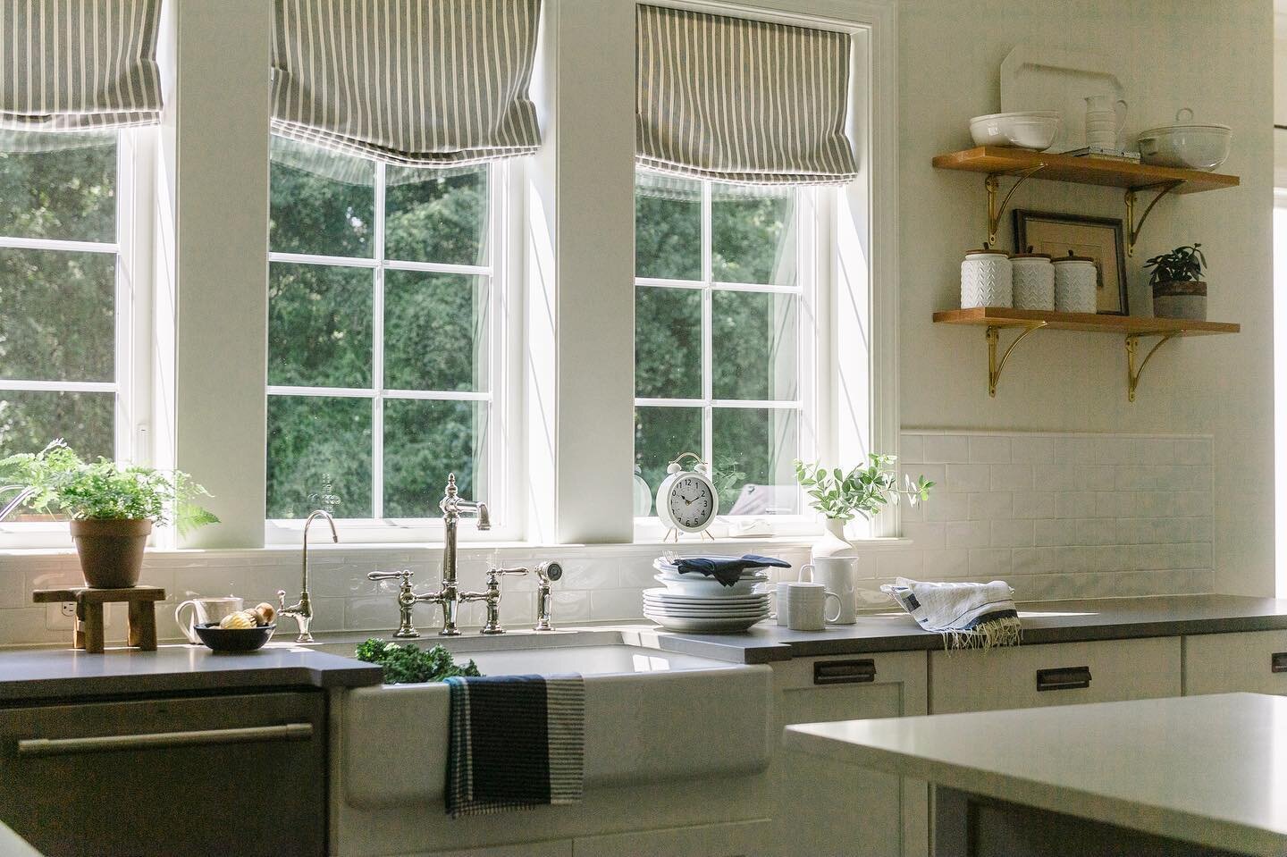 Morning light. Three windows with handsome roman shades. One of our favorite livable family kitchens with all the details. @spencephoto