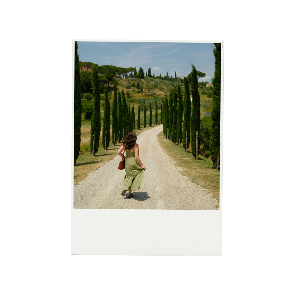 Gondolas docked along the water in Venice with buildings and a church with a bell tower in the background under a hazy sky.
