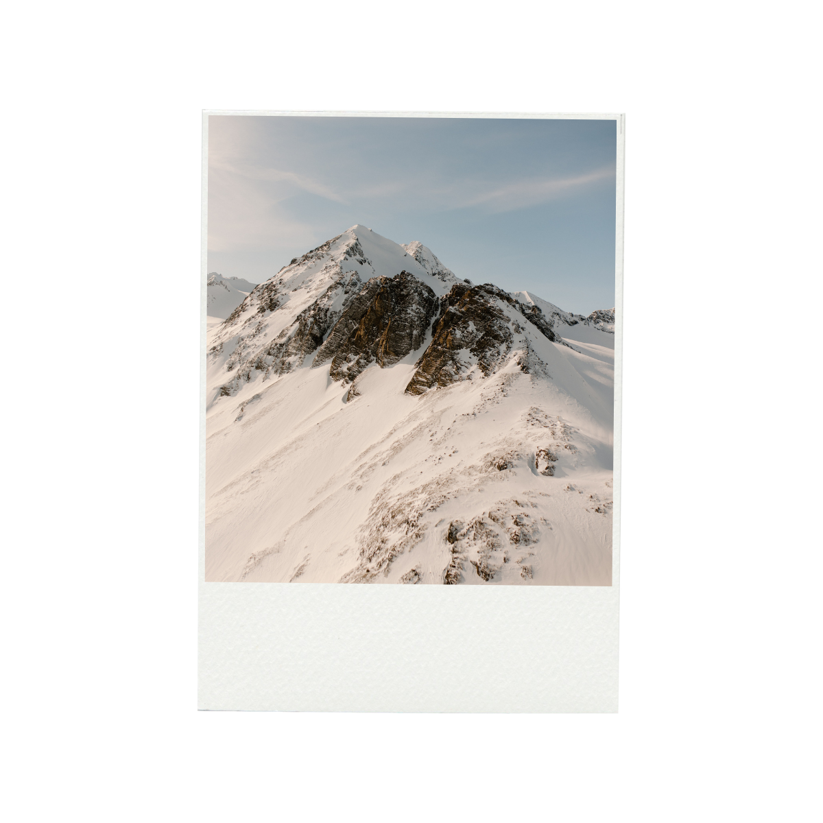 Icebergs in icy waters with snow-covered mountains in the background during daylight.
