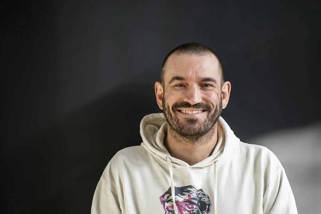 Headshot of Andrew Mendlik against dark background