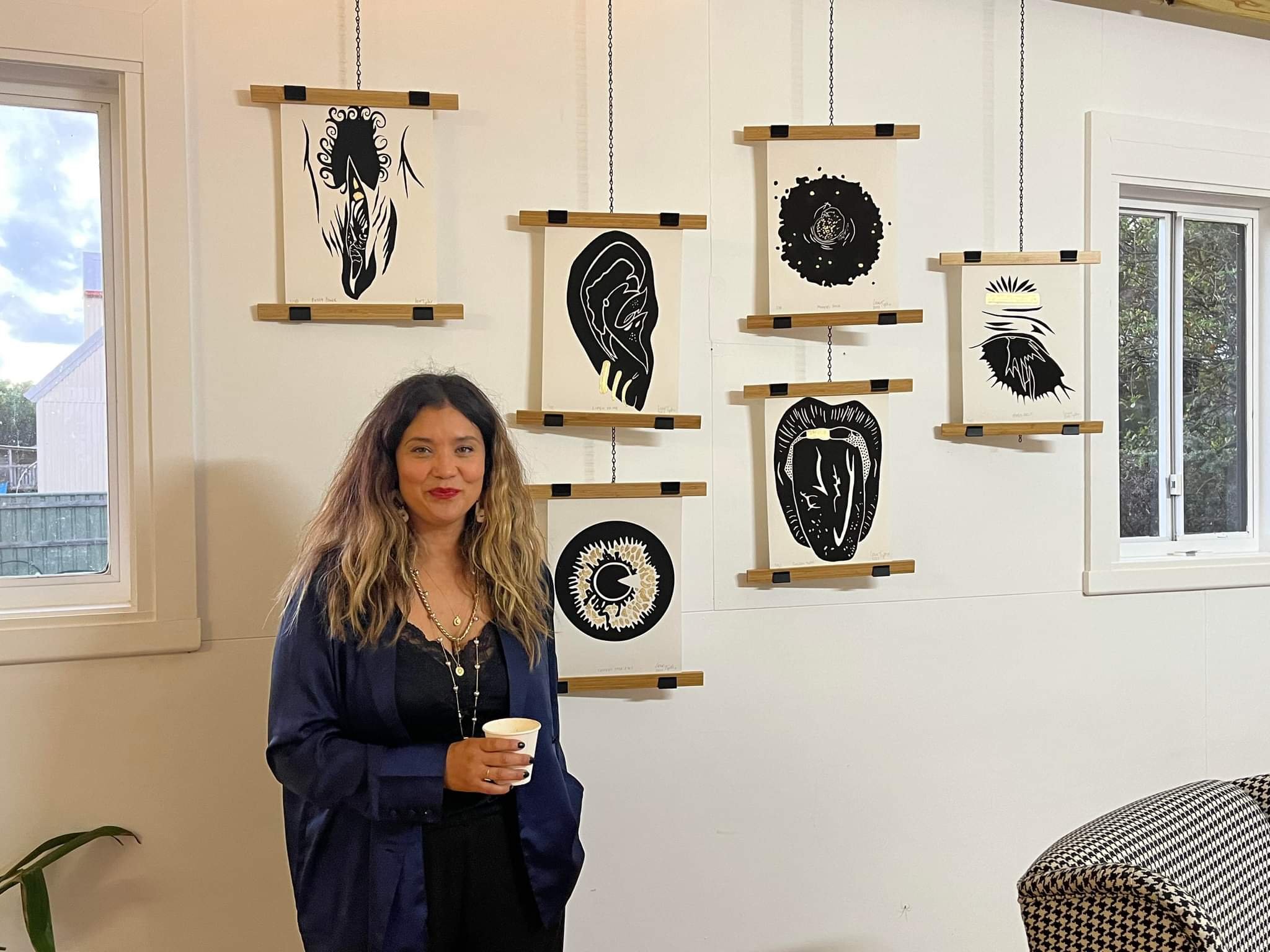 Tiphaine de Fleurette Hunter-Brown A.K.A Floreo Creative standing in front of her limited edition Gestures prints at The Project Space Apollo Bay