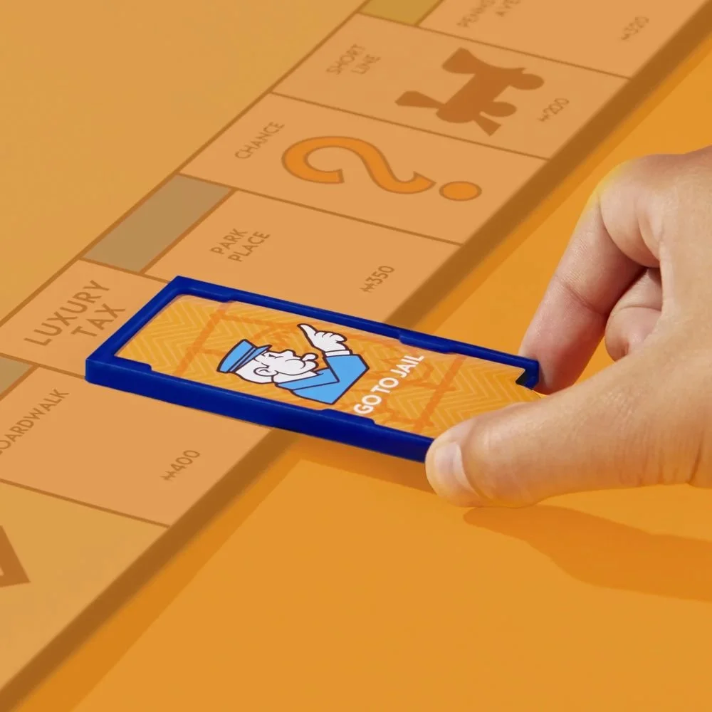 monopoly-go-to-jail-expansion-add-to-classic-monopoly-game-family-games-ages-8-40-mins_2-edit.jpg