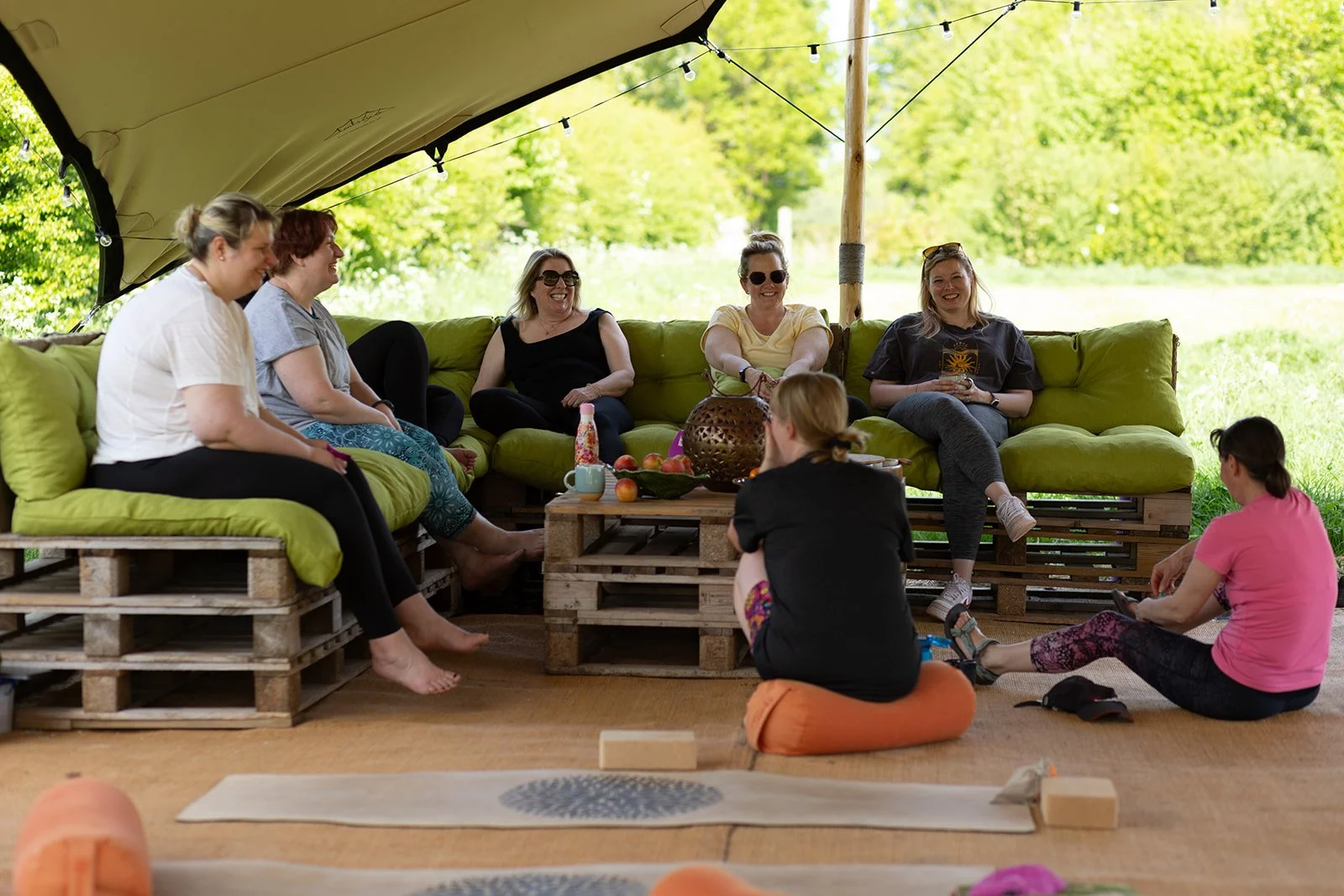 Group of women sat in the shade on a sunny day chatting